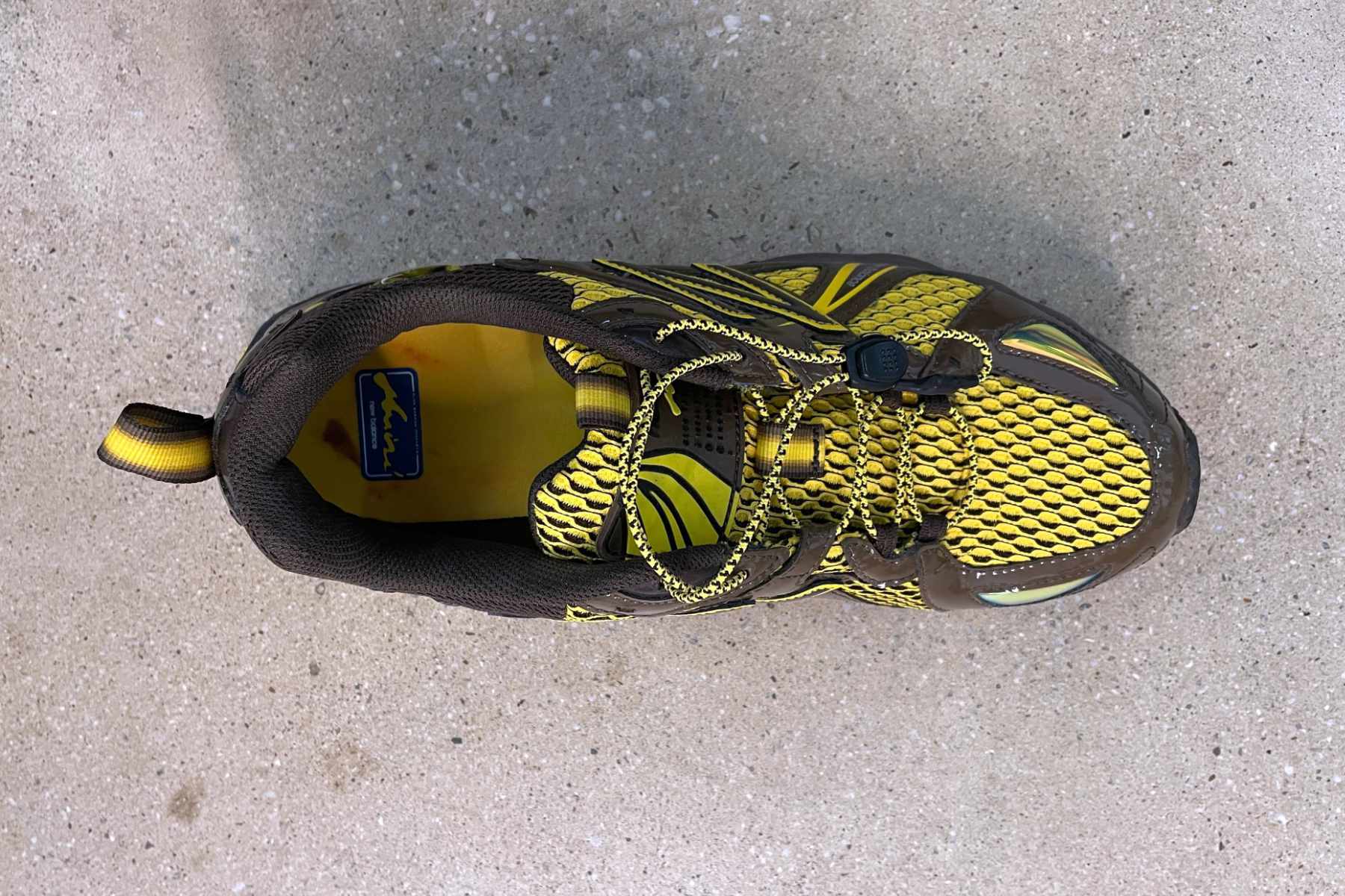 Amine's New Balance 610 shoe, "The Mooz," in brown and yellow colors photographed from the top-down