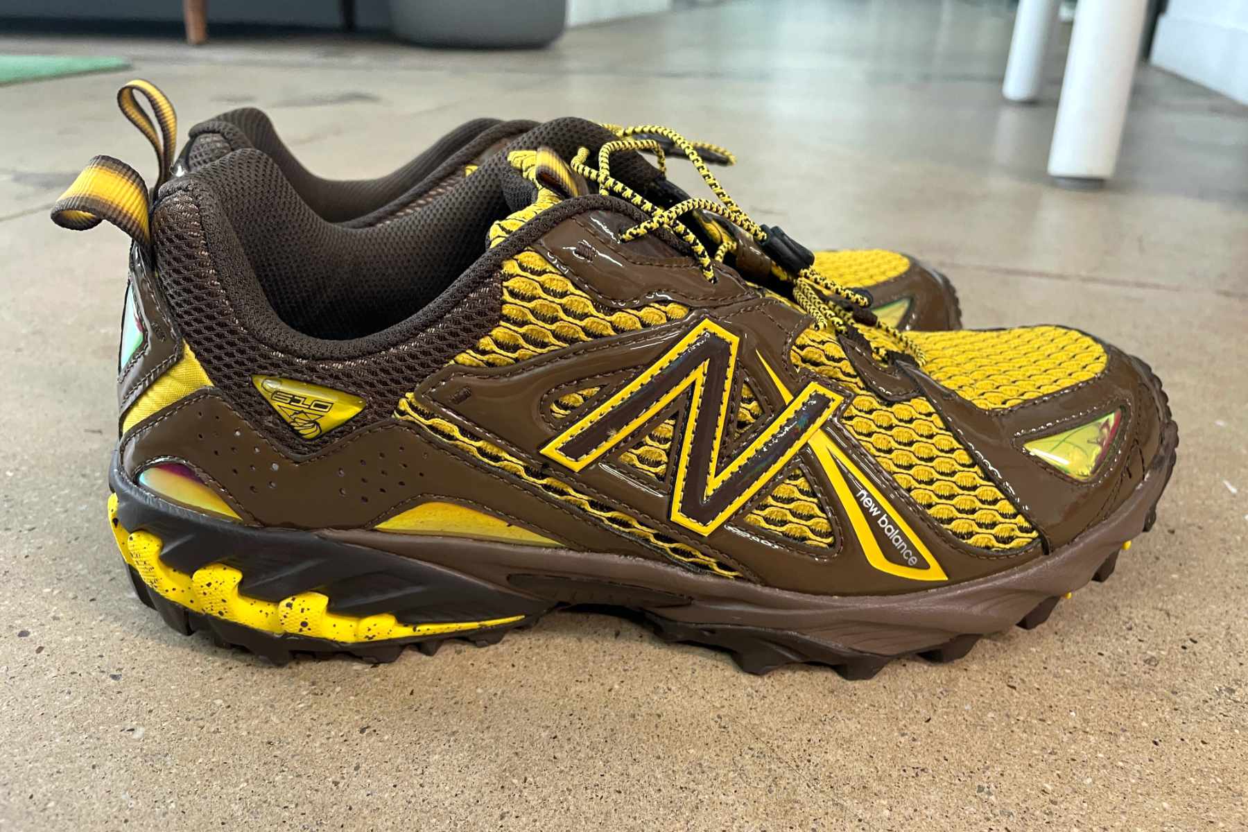 Amine's New Balance 610 shoe, "The Mooz," in brown and yellow colors photographed from the outside