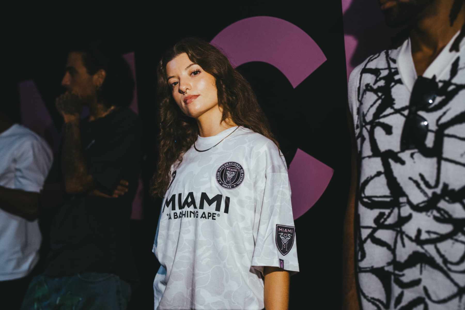 A model wears BAPE & Inter Miami's collaborative pink jersey