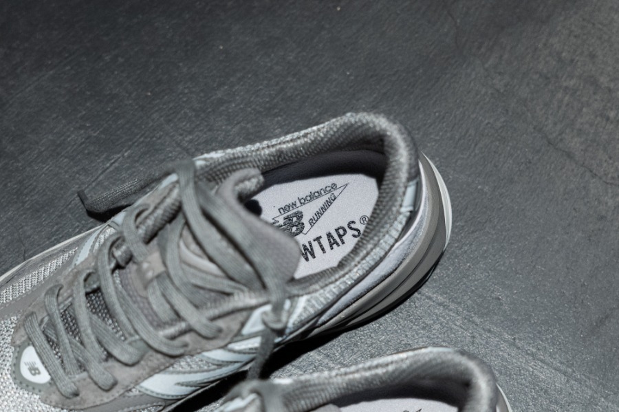 A top-down view of WTAPS & New Balance's 990v6 grey sneaker collab