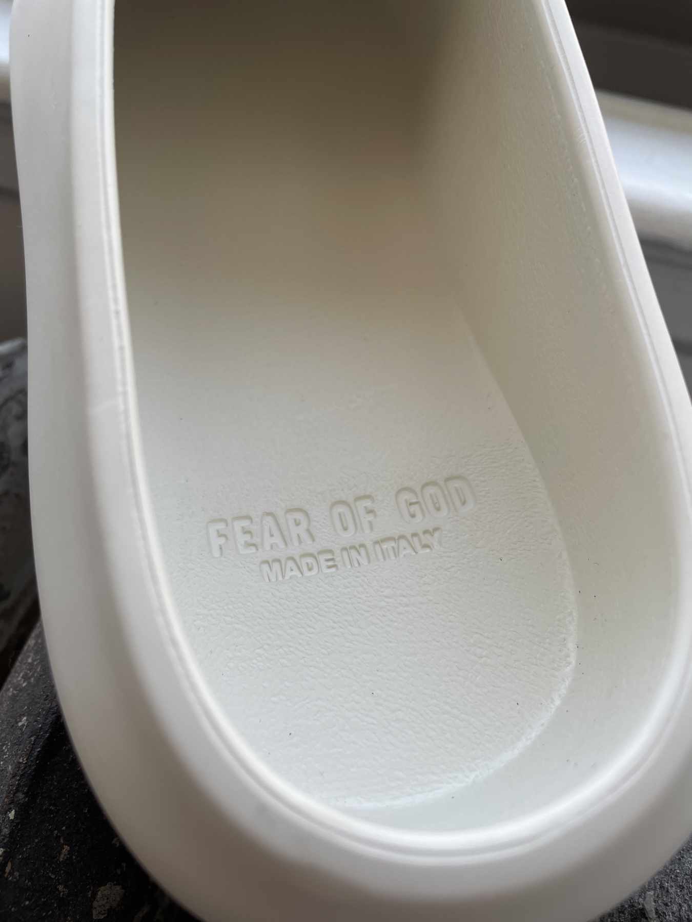 A detailed photograph showing the insole of Fear of God's California 2.0 slip-on shoe in Cream