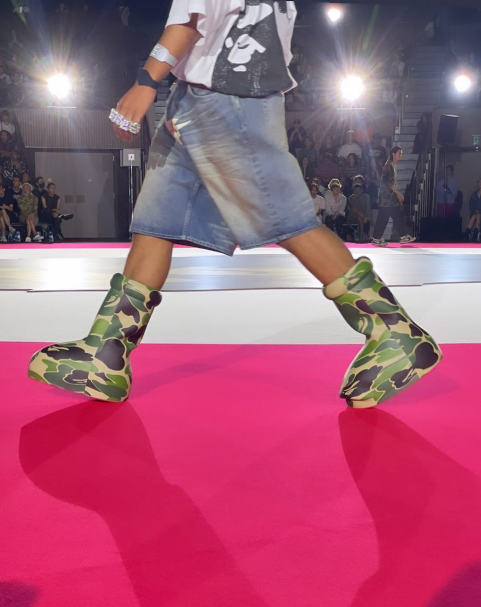 BAPE & MSCHF's pink and green camo-covered Big Red Boot, seen worn by models during the Tokyo Fashion Week runway show