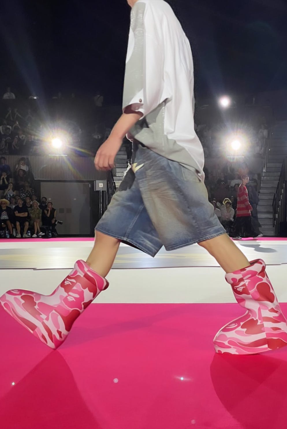 BAPE & MSCHF's pink and green camo-covered Big Red Boot, seen worn by models during the Tokyo Fashion Week runway show