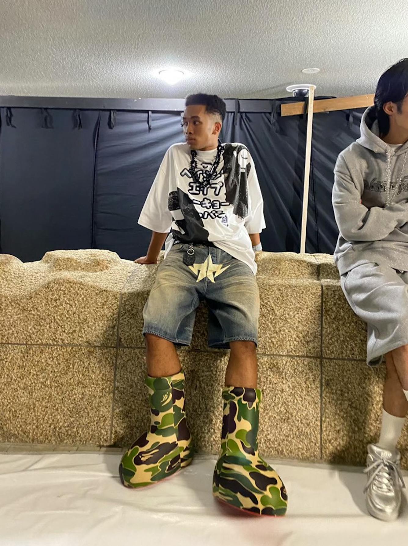 BAPE & MSCHF's pink and green camo-covered Big Red Boot, seen worn by models during the Tokyo Fashion Week runway show