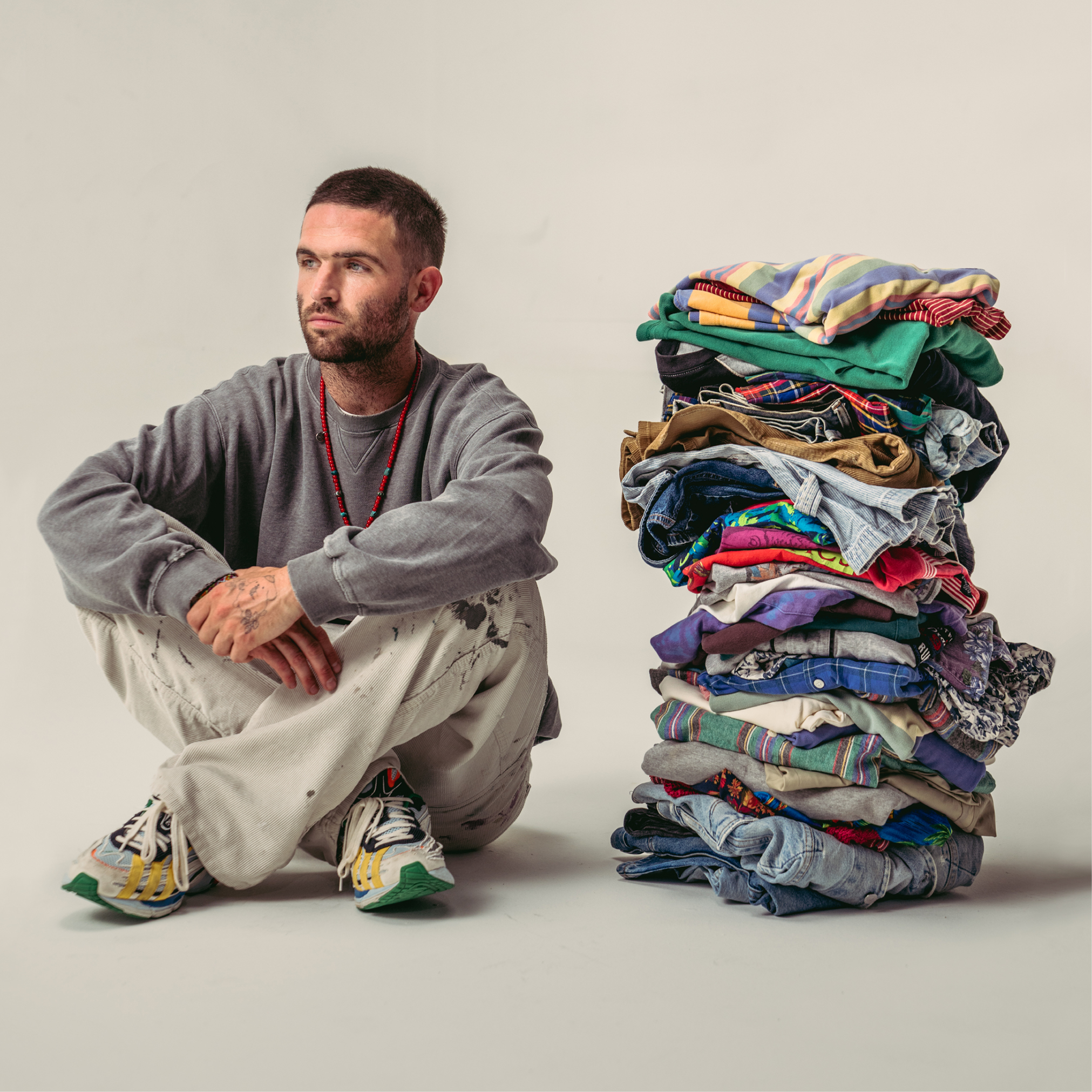 Designer Sean Wotherspoon sits next to a pile of vintage GAP clothes