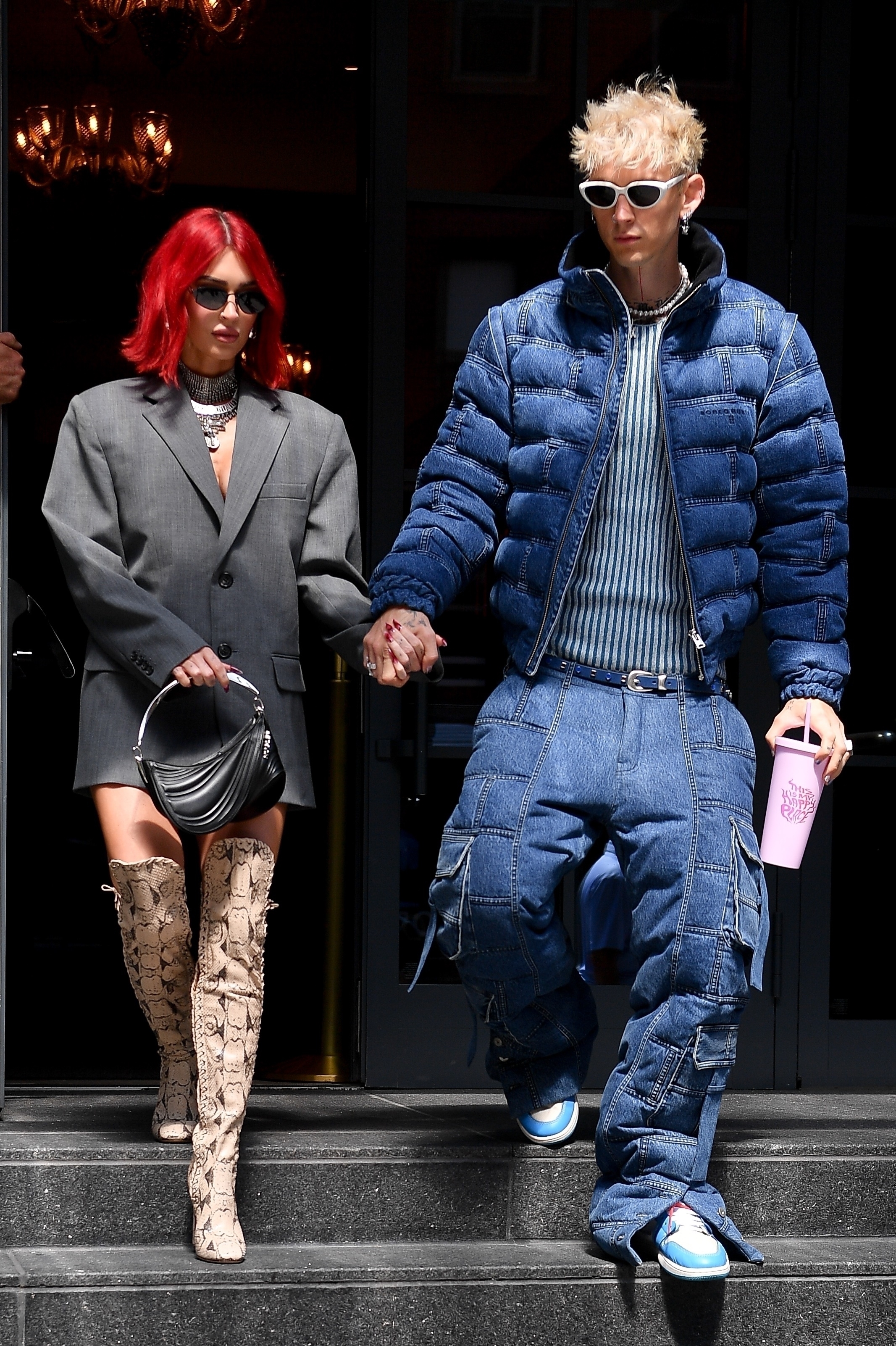 Machine Gun Kelly & Megan Fox leave a hotel on September 5, 2023, he in a denim puffer with cargo pants to match and she in a blazer and knee-high boots.
