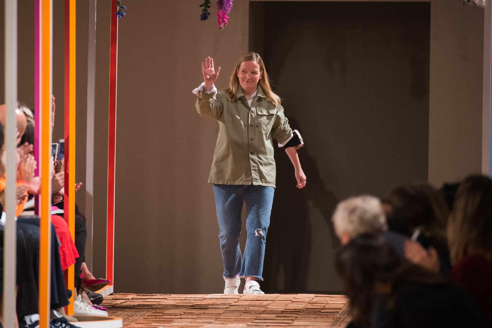 Alexander McQueen Creative Director Sarah Burton waves at the end of the 2018 runway show
