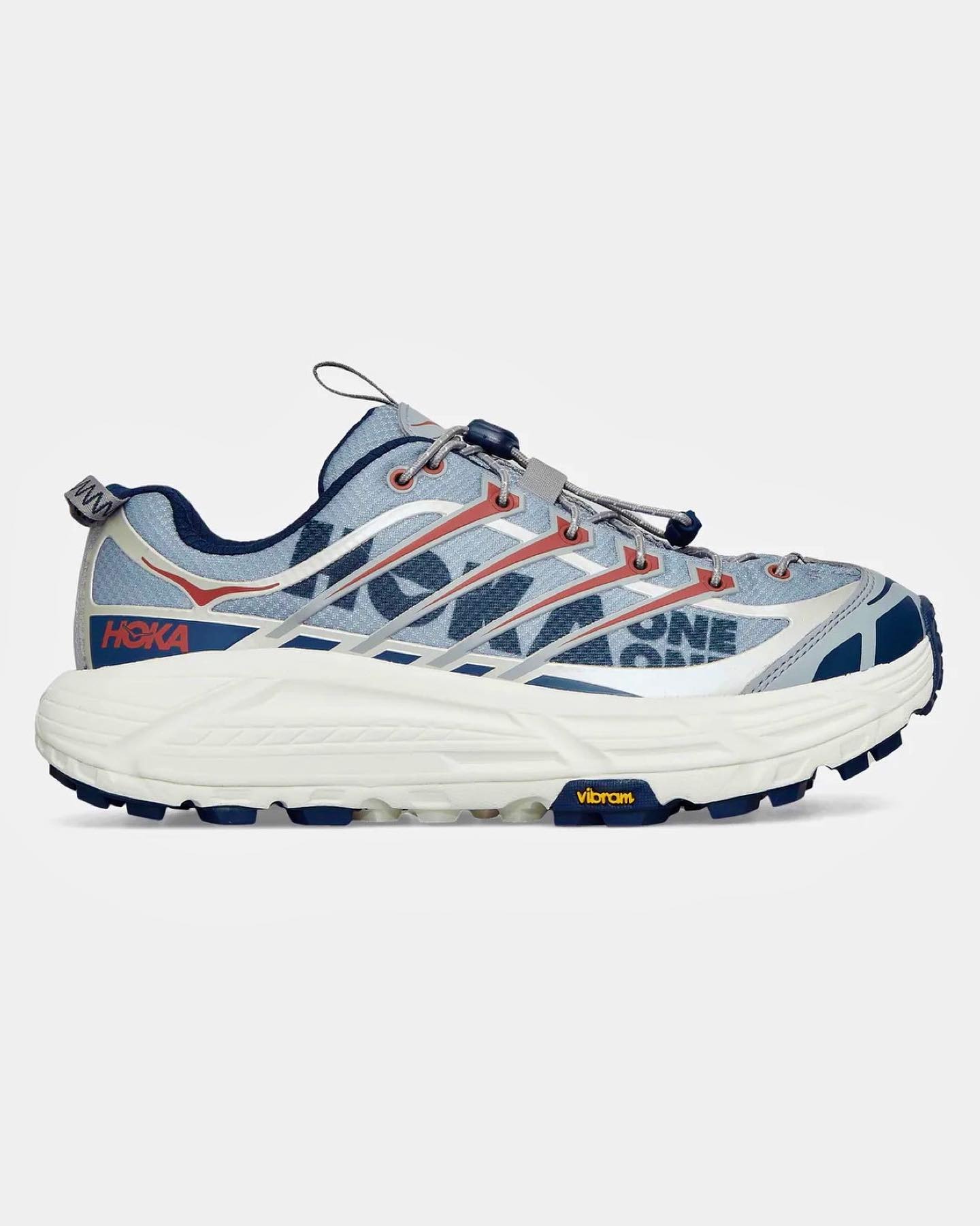 A photograph of HOKA's Mafate Three Two sneaker in a blue and white colorway with Vibram sole