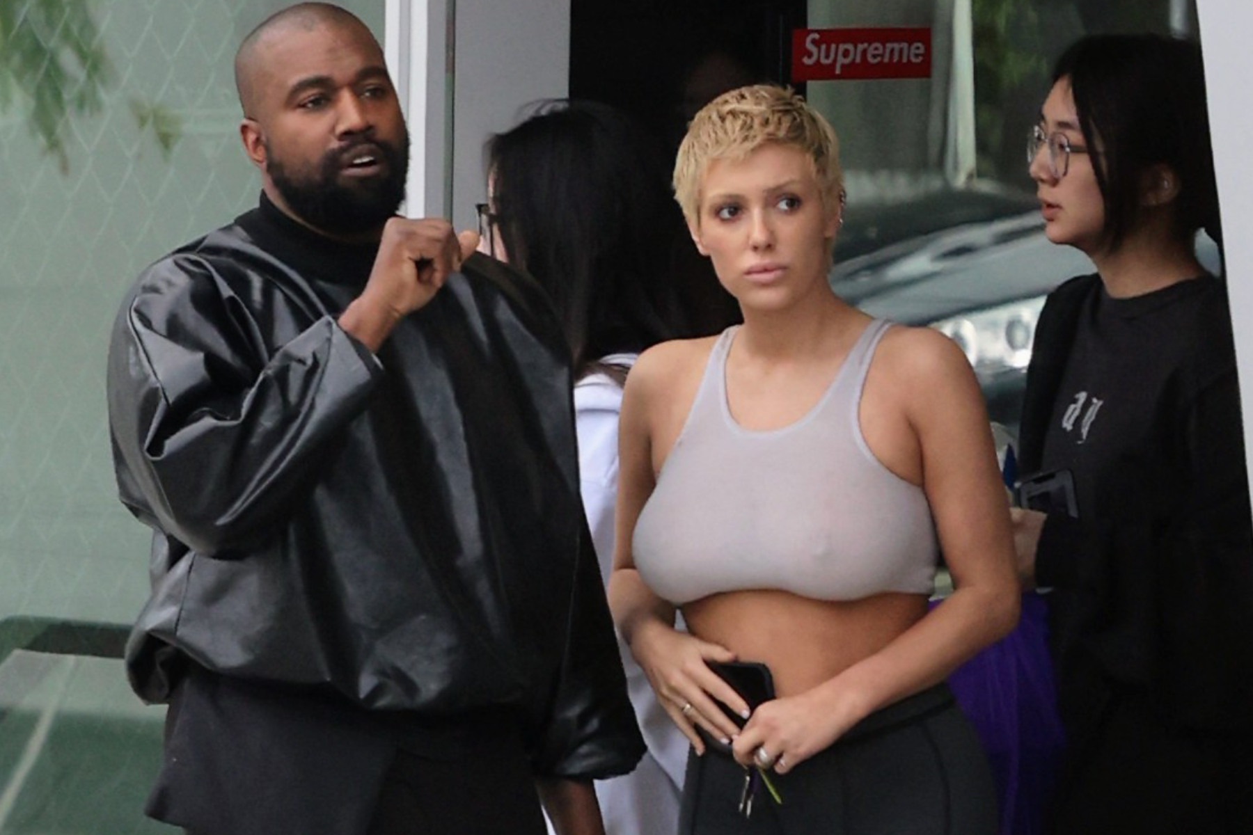 kanye west & wife bianca censori are seen wearing a leather jacket (Ye) and see-through sports bra (Bianca)