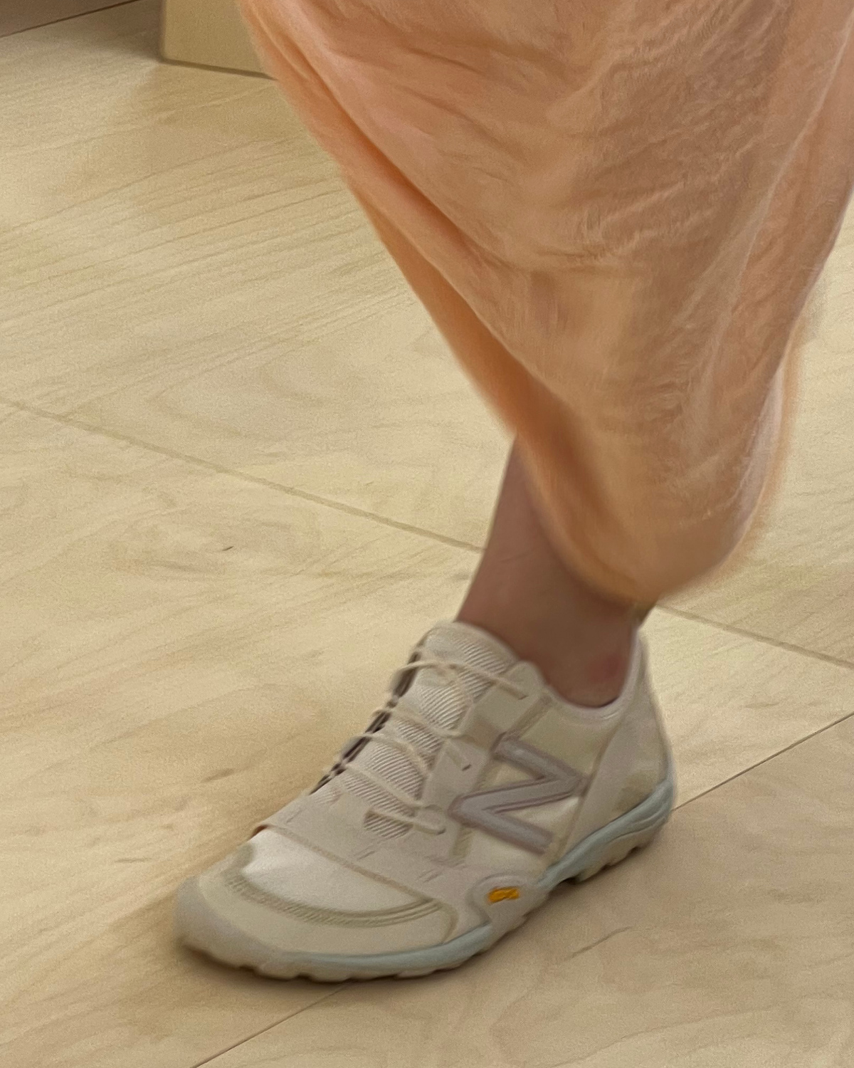 A mode wears Issey Miyake & New Balance's collaborative sneaker at the Spring/Summer 2024 fashion show