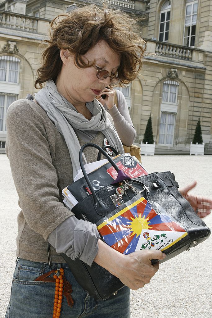 Jane Birkin holding her signature Birkin bag