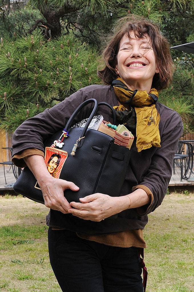 Jane Birkin holding her signature Birkin bag