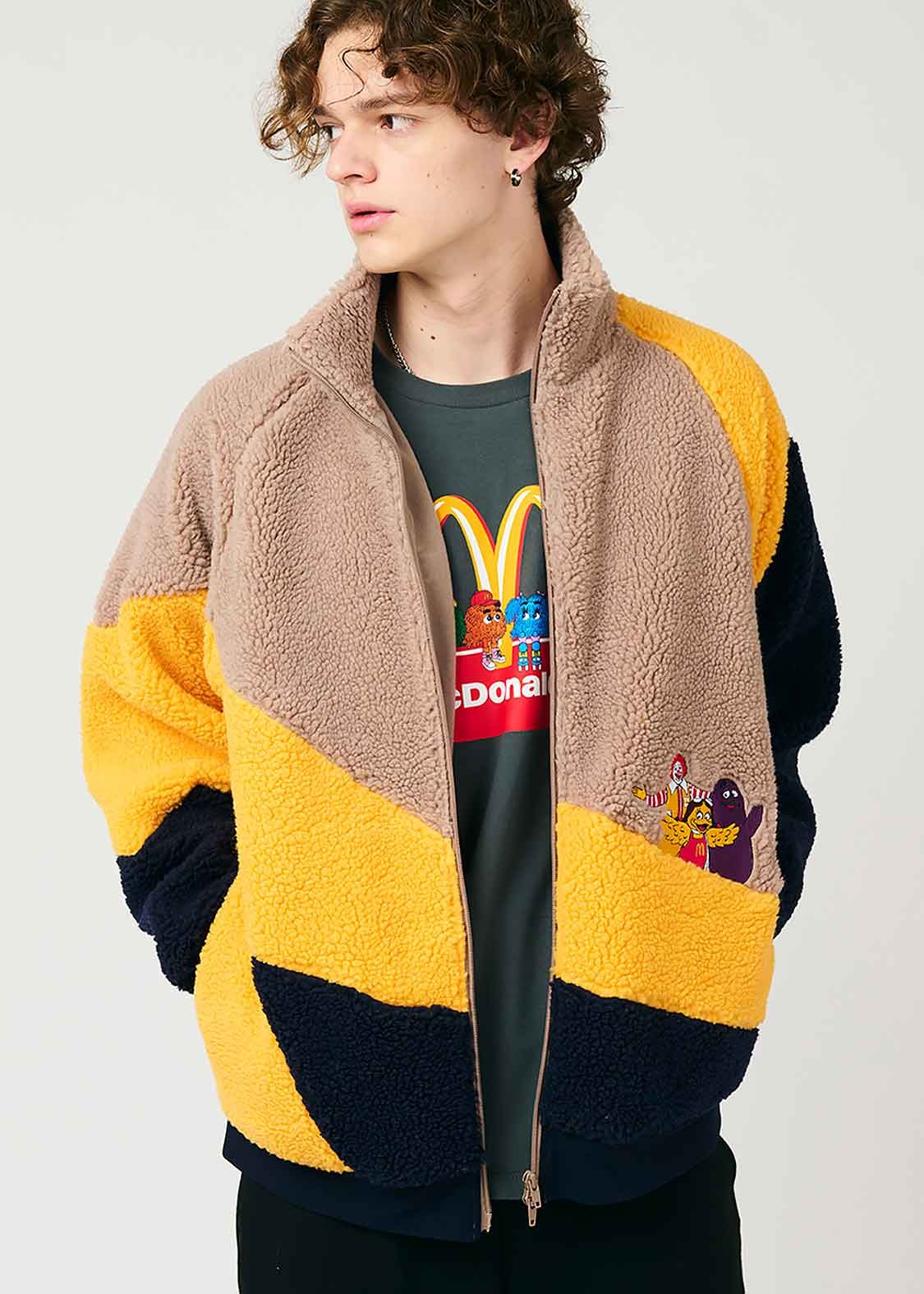 A model wears McDonald's x Graniph collaborative clothing & paper bag