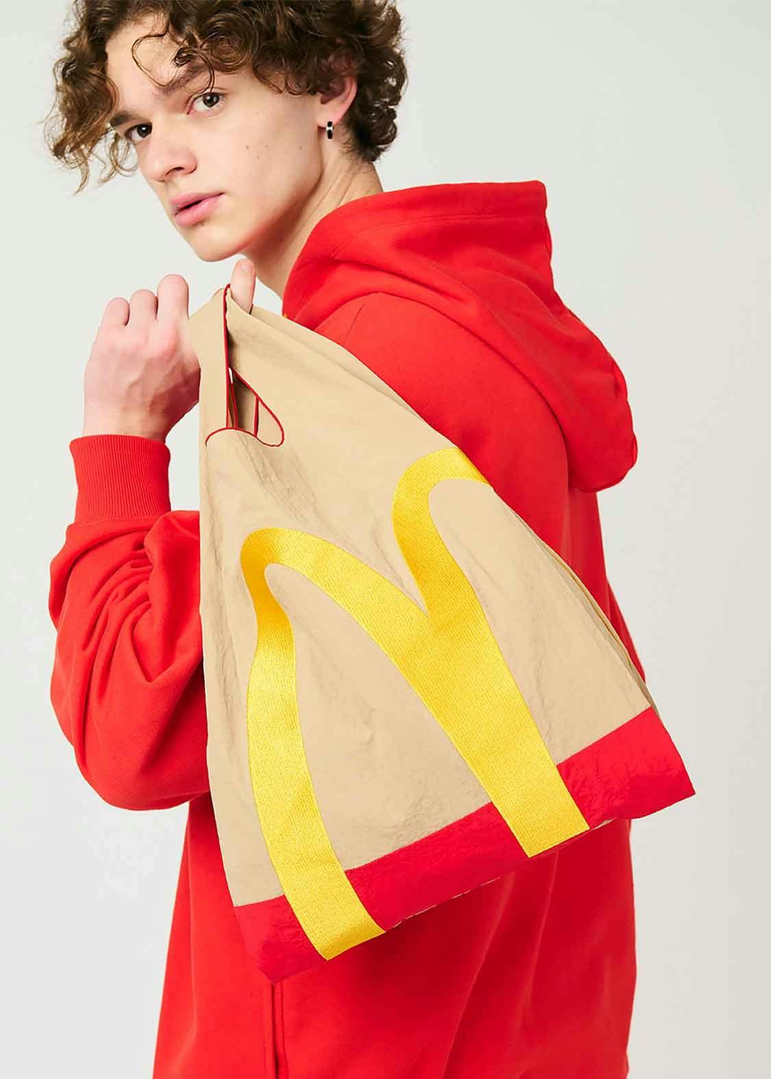 A model wears McDonald's x Graniph collaborative clothing & paper bag