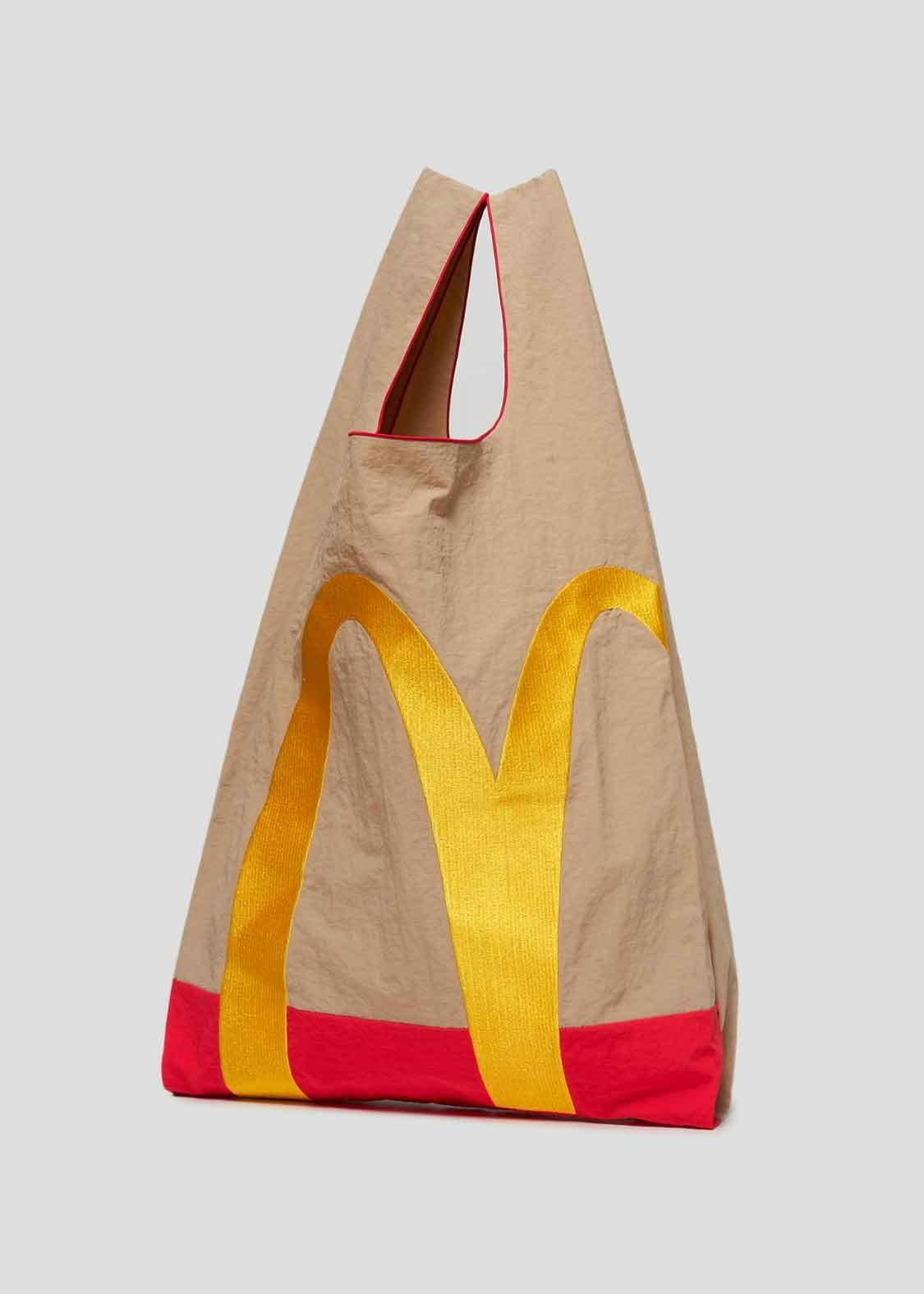 A model wears McDonald's x Graniph collaborative clothing & paper bag