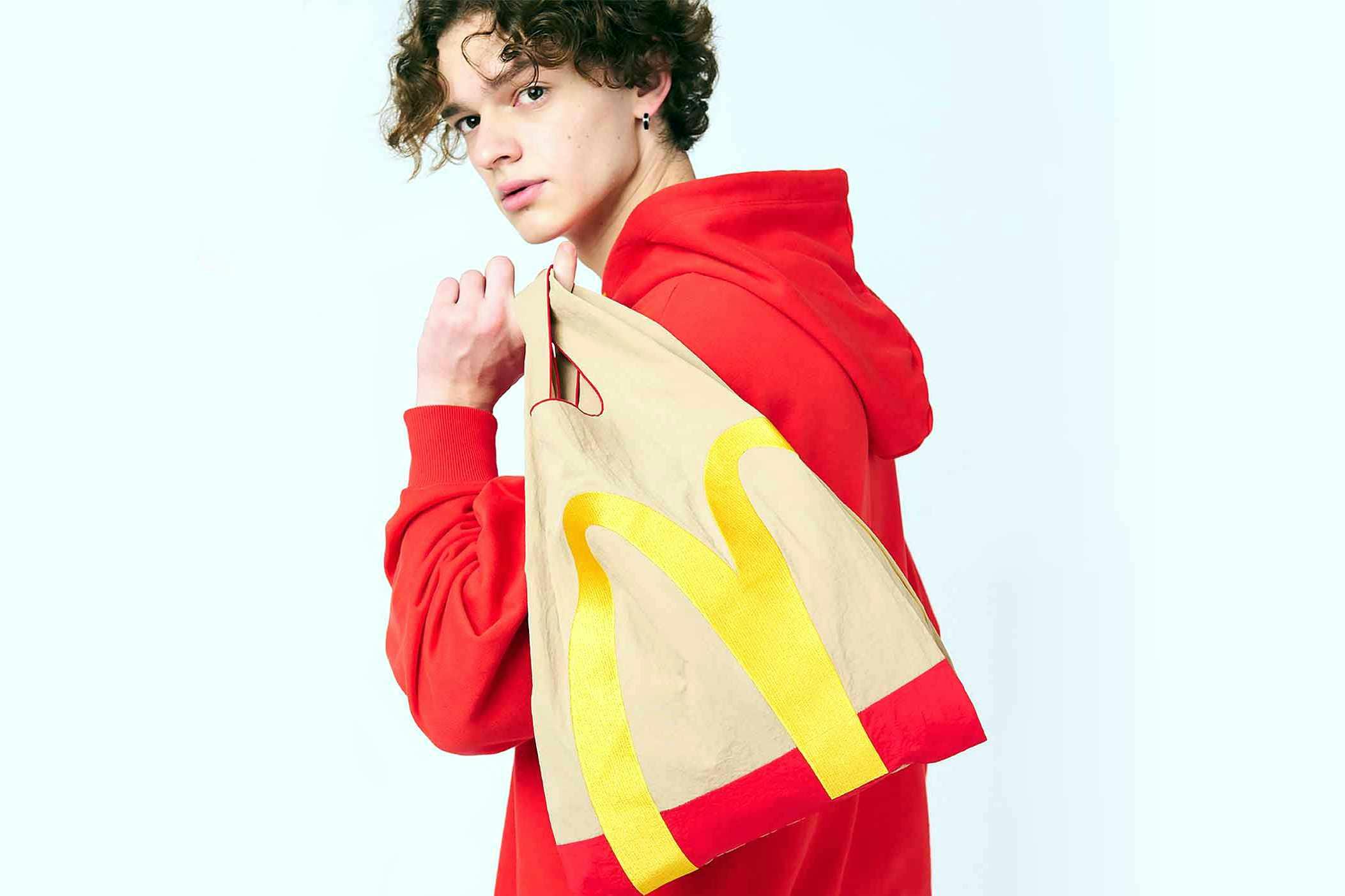 A model wears McDonald's x Graniph collaborative clothing & paper bag