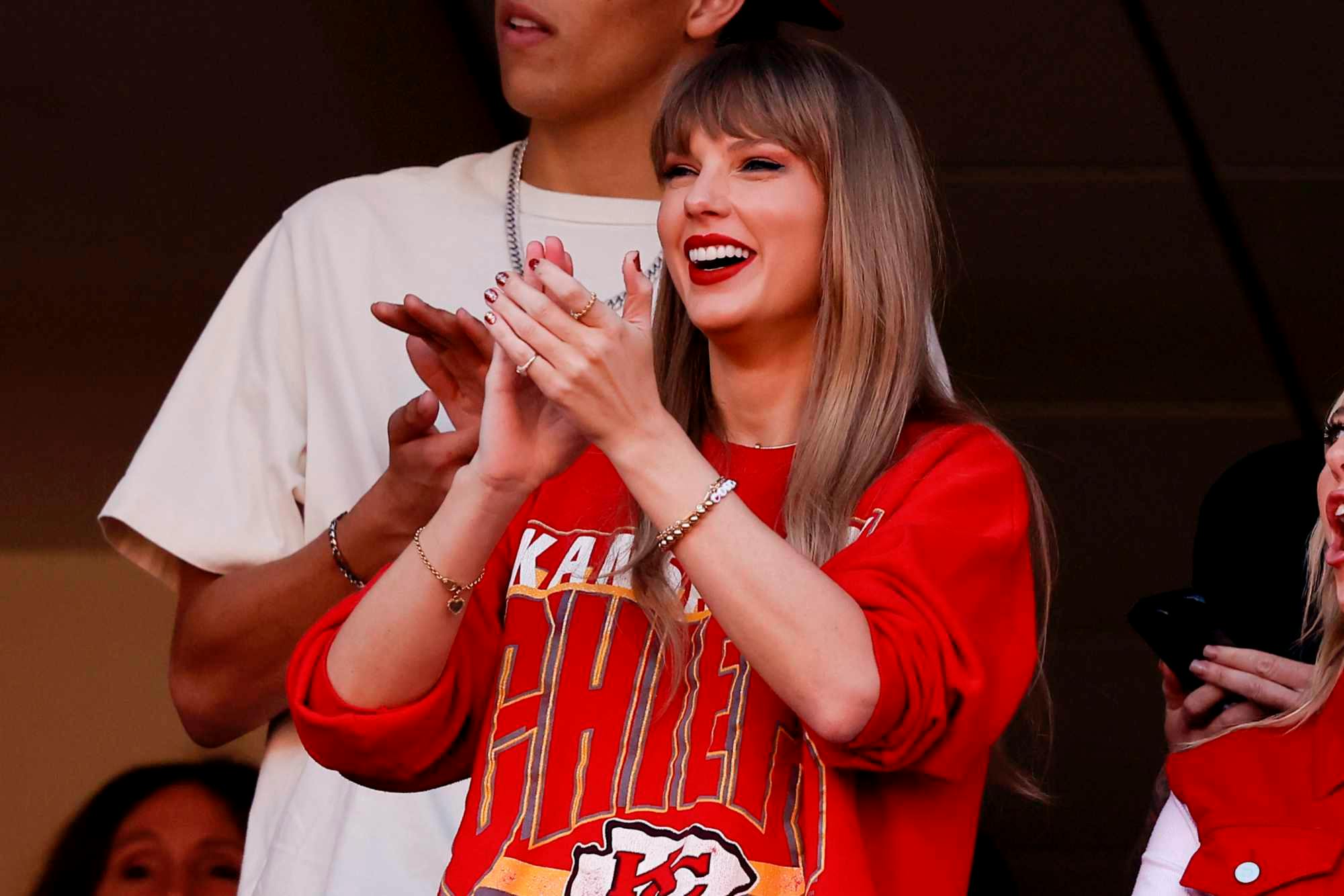 Taylor Swift wears a Kansas City Chiefs T-shirt on October 22 watching boyfriend Travis Kelce play football