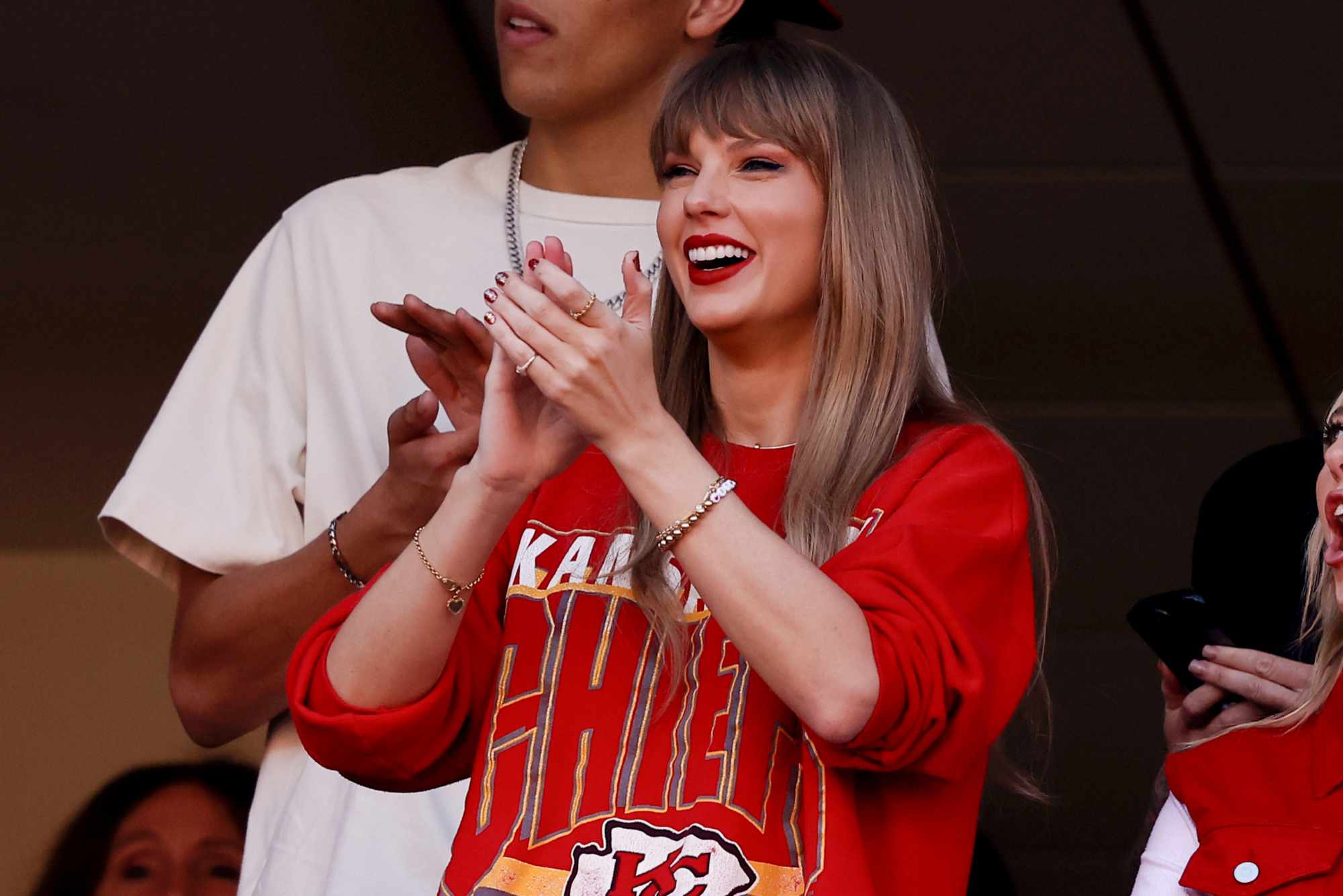 Taylor Swift wears a Kansas City Chiefs T-shirt on October 22 watching boyfriend Travis Kelce play football