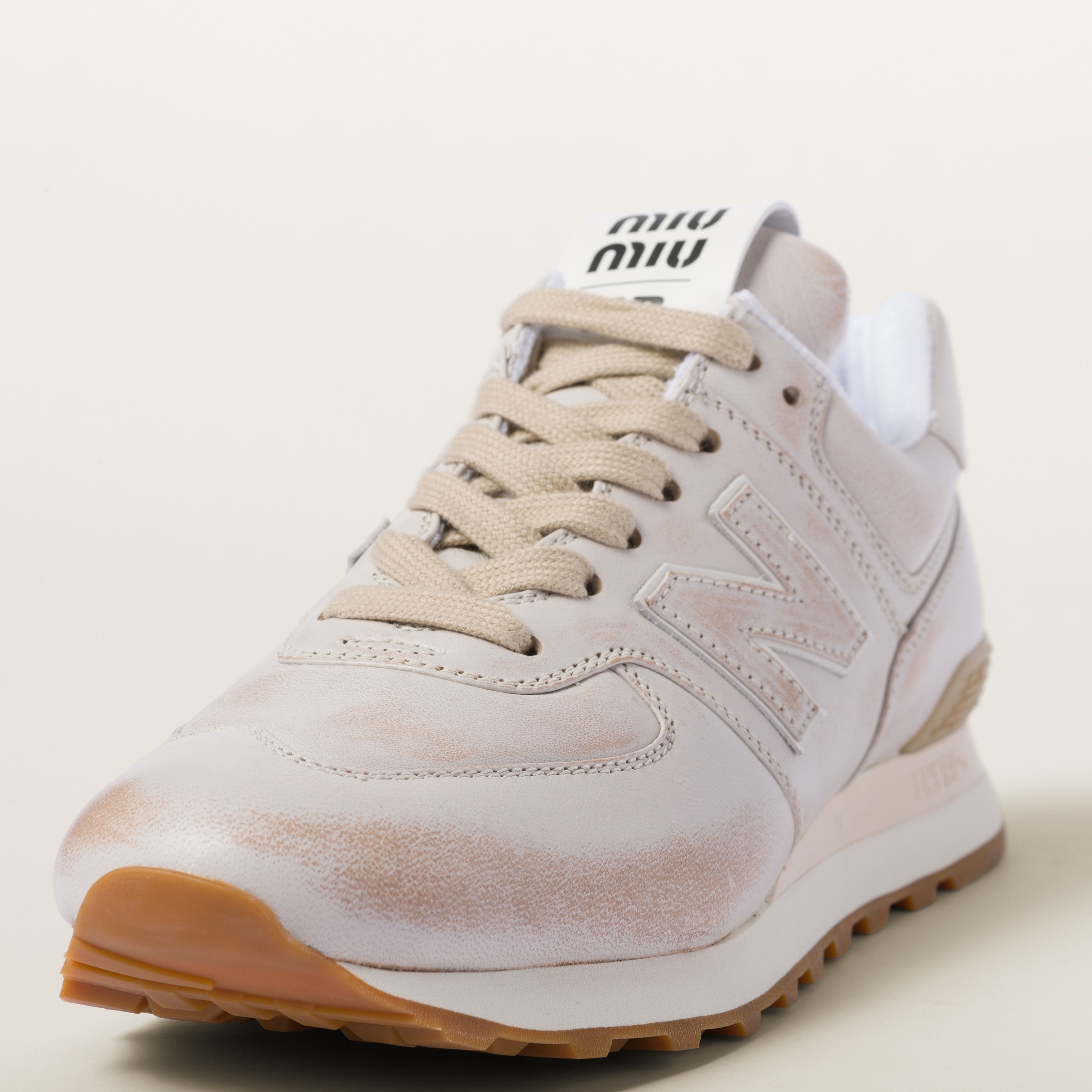 Miu Miu & New Balance's 574 sneaker collaboration with soft velvet & distressed leather uppers