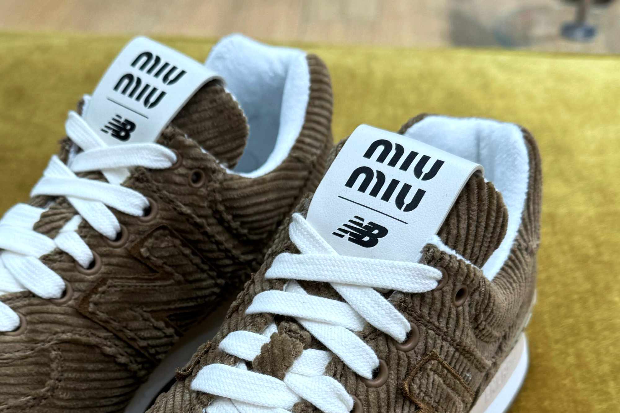 In-hand photographs of Miu Miu & New Balance's velvet 574 sneaker