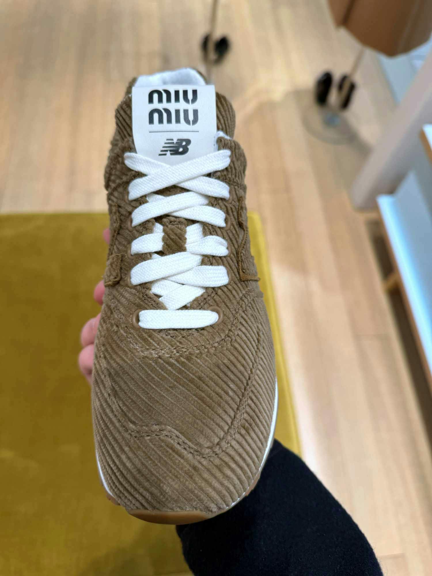 In-hand photographs of Miu Miu & New Balance's velvet 574 sneaker