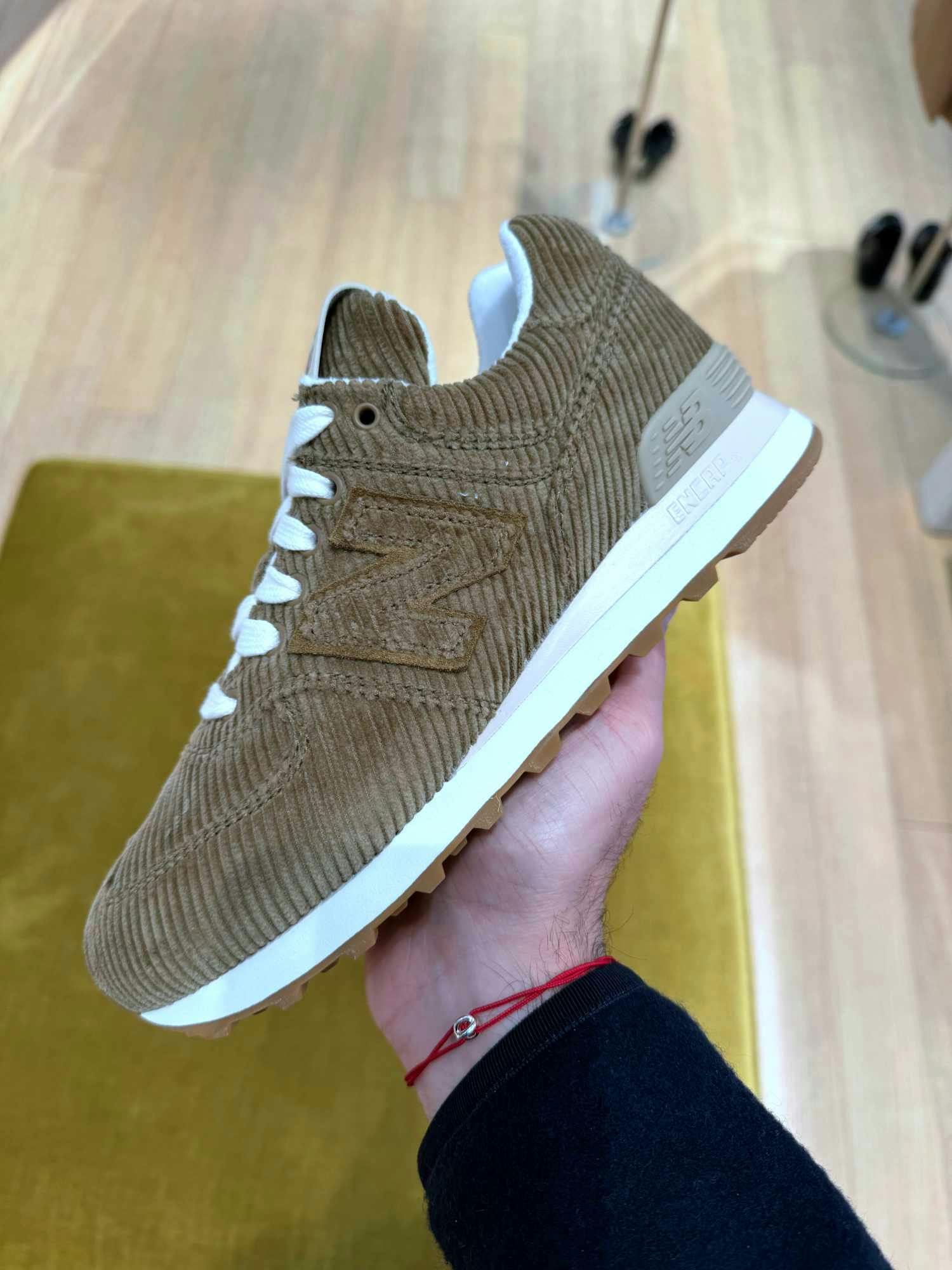 In-hand photographs of Miu Miu & New Balance's velvet 574 sneaker