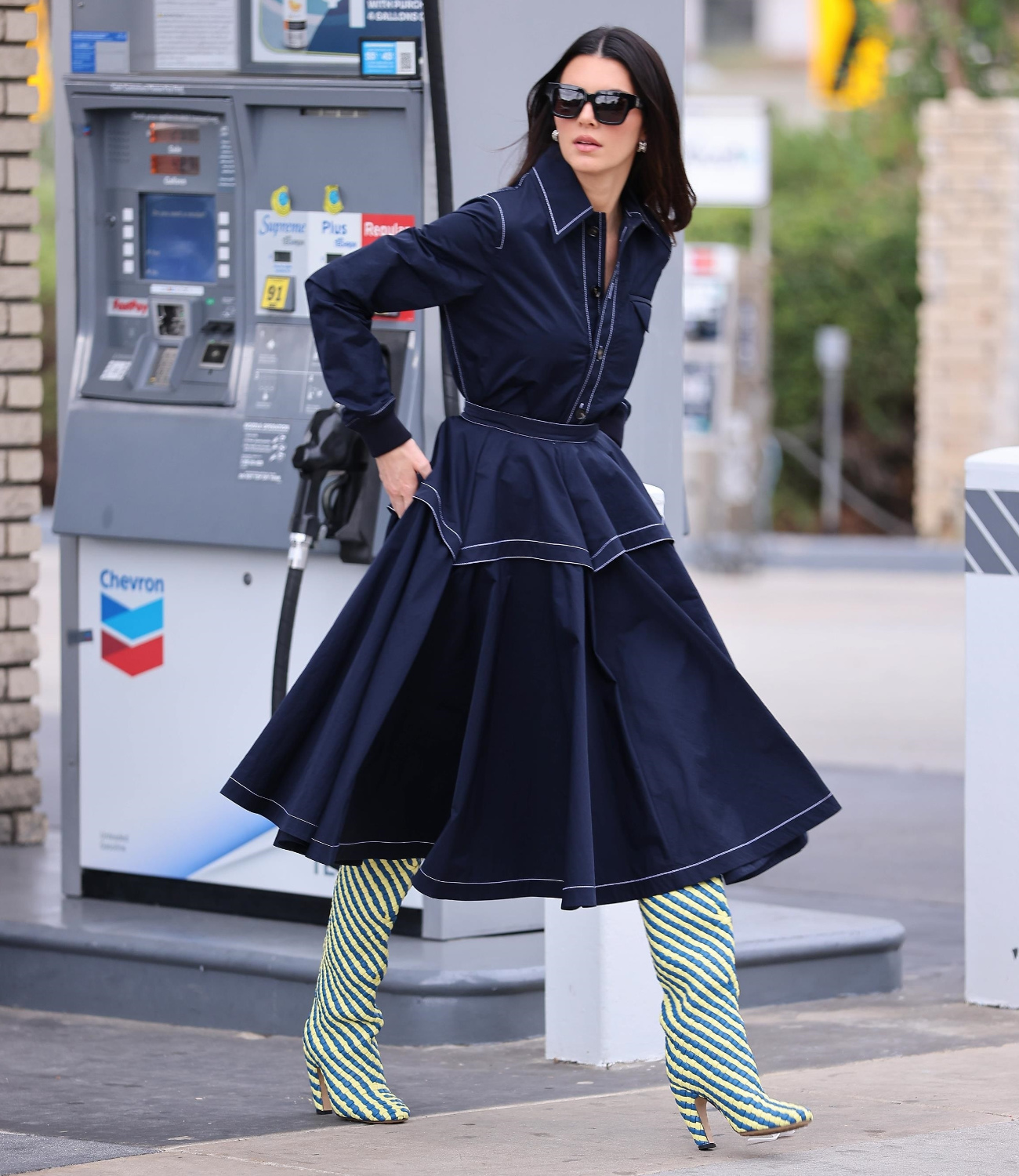 Kendall Jenner wearing Bottega Veneta's new Over-The-Knee boots at the gas station.