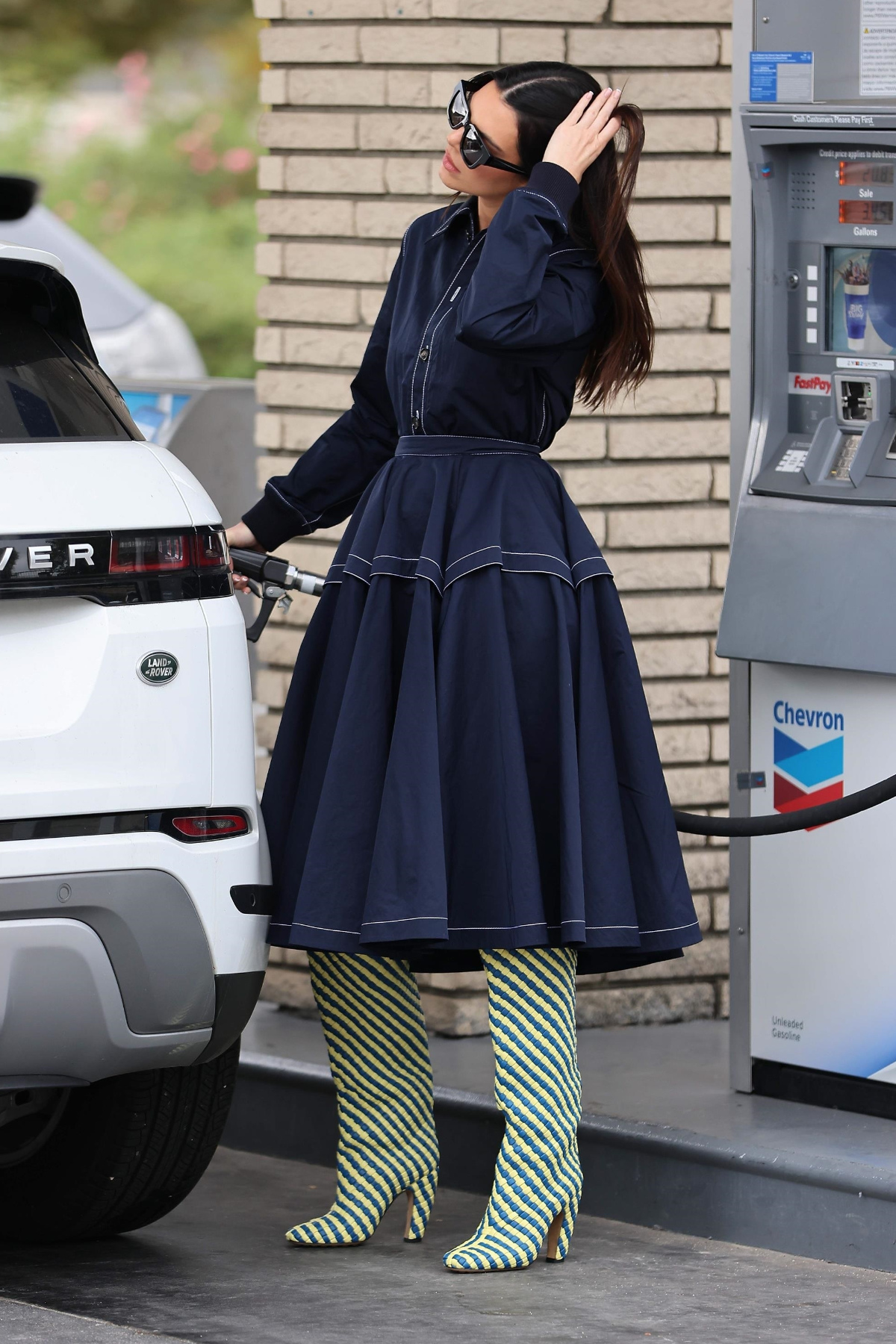 Kendall Jenner wearing Bottega Veneta's new Over-The-Knee boots at the gas station.