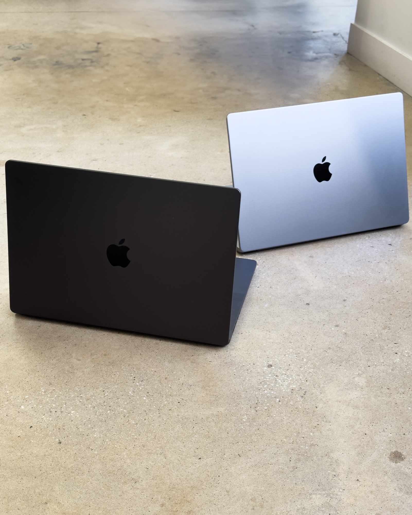 Photographs of Apple's grey and black 2023 MacBook Pro computers with the M3 chip