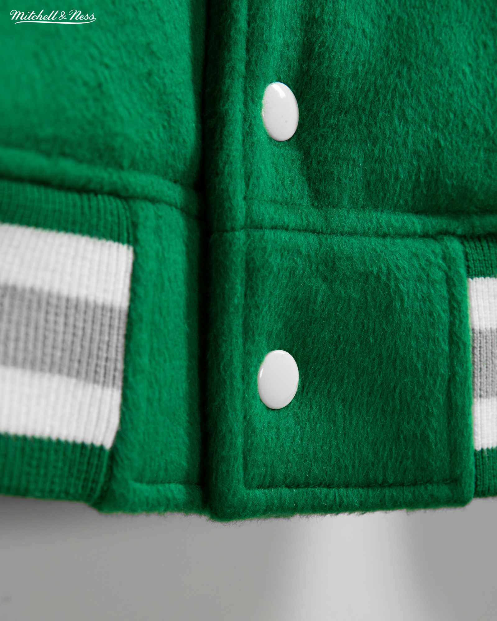 Product photos of Mitchel & Ness' Princess Diana Eagles jacket recreation in green wool and silver leather releasing in November 2023