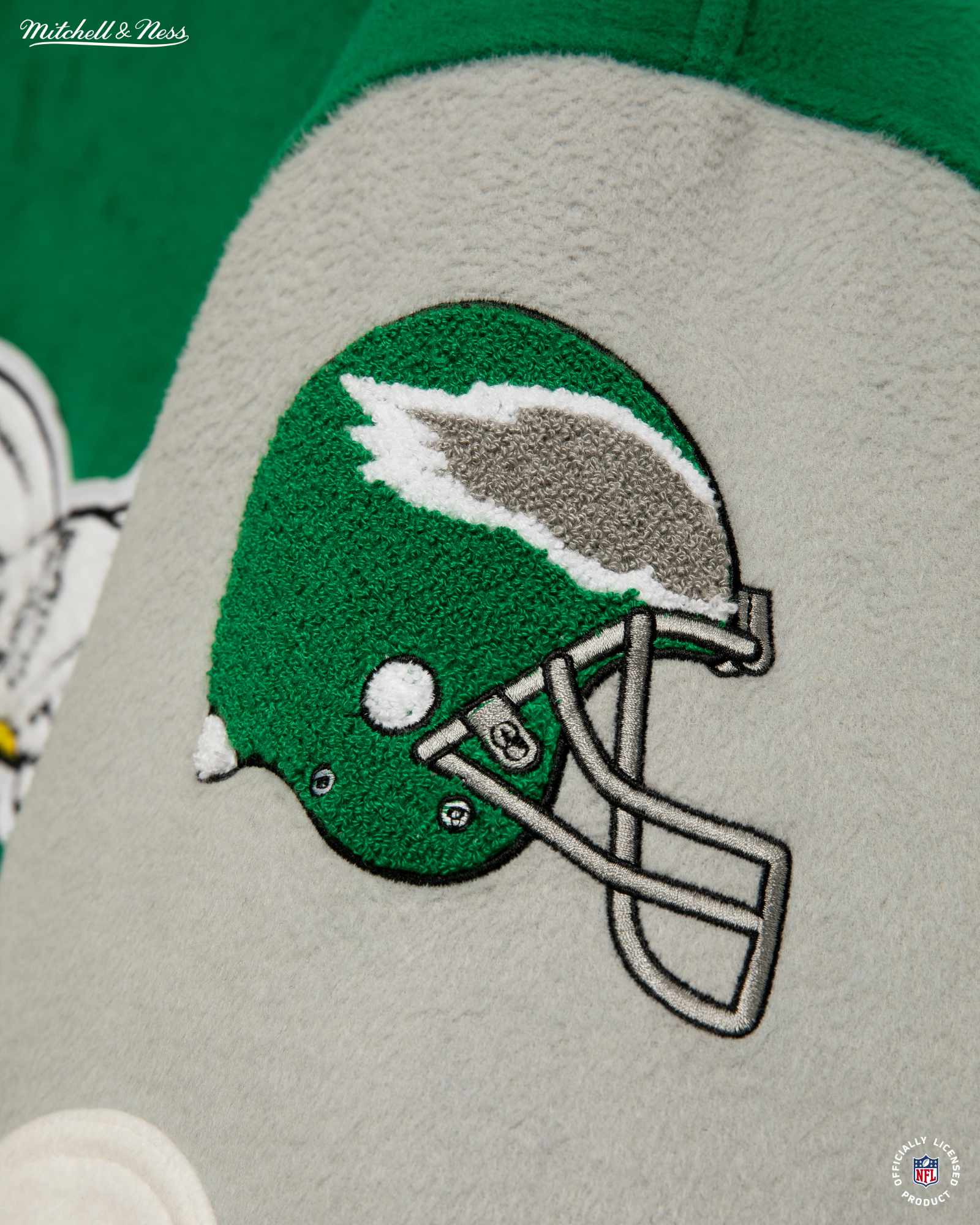 Product photos of Mitchel & Ness' Princess Diana Eagles jacket recreation in green wool and silver leather releasing in November 2023