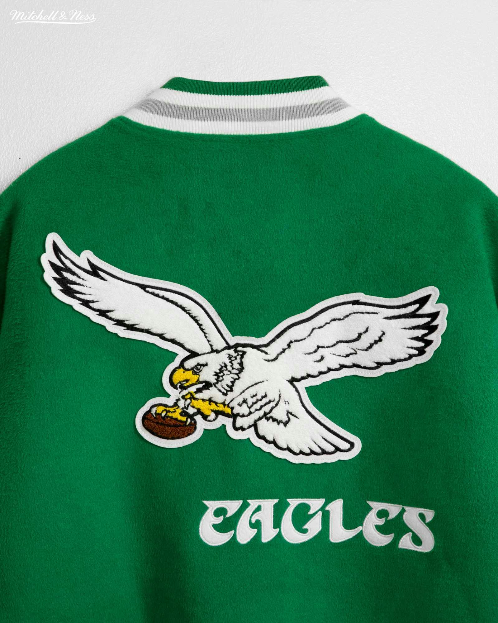 Product photos of Mitchel & Ness' Princess Diana Eagles jacket recreation in green wool and silver leather releasing in November 2023