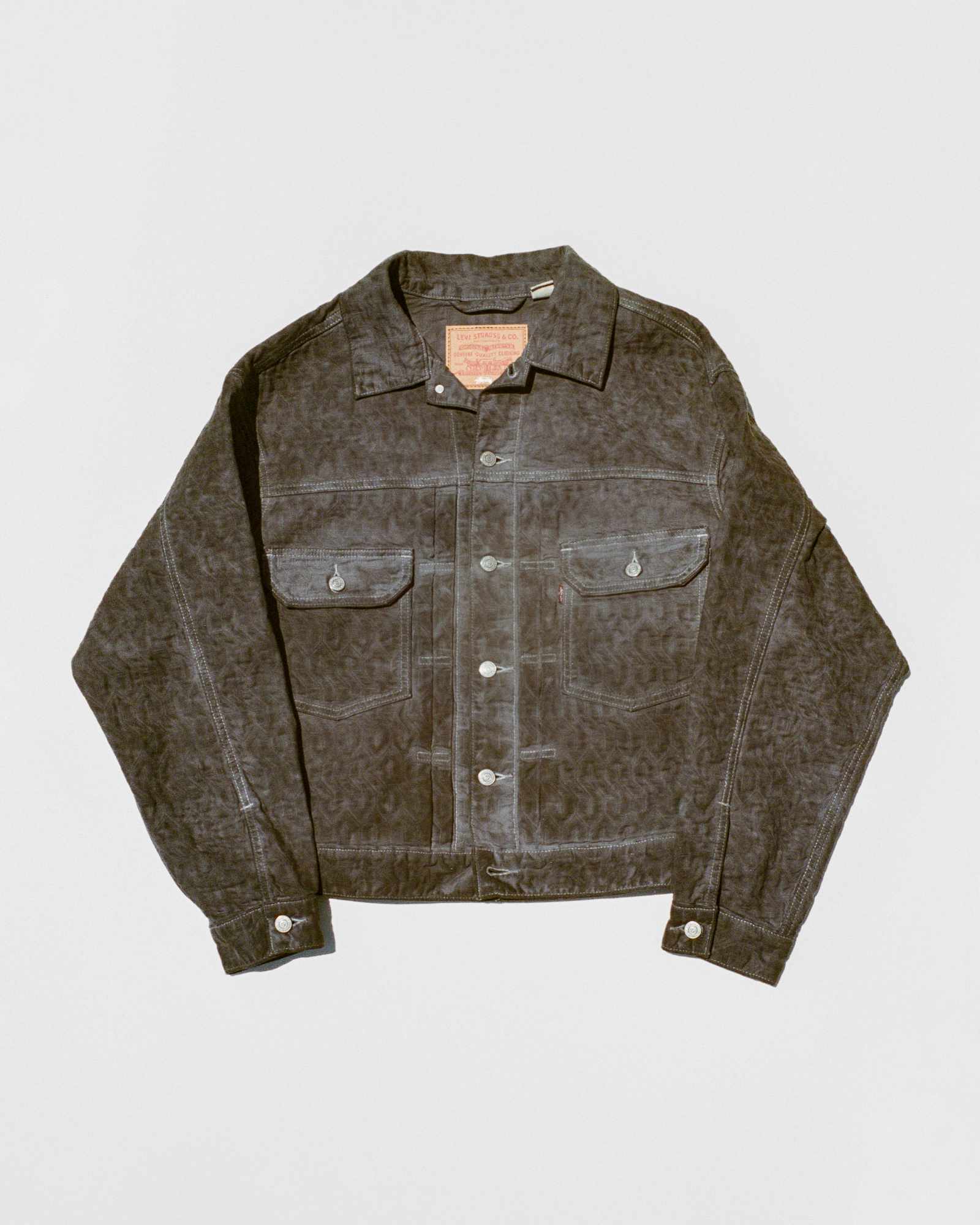 Models wear Stussy & Levi's overdyed brown, beige, and grey denim trucker jackets and 501 jeans