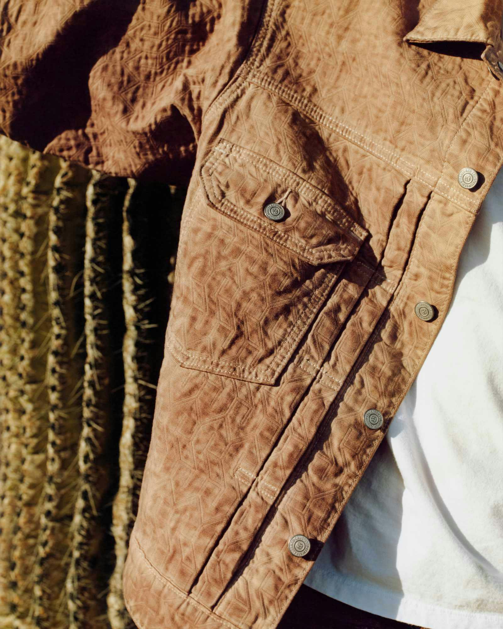 Models wear Stussy & Levi's overdyed brown, beige, and grey denim trucker jackets and 501 jeans