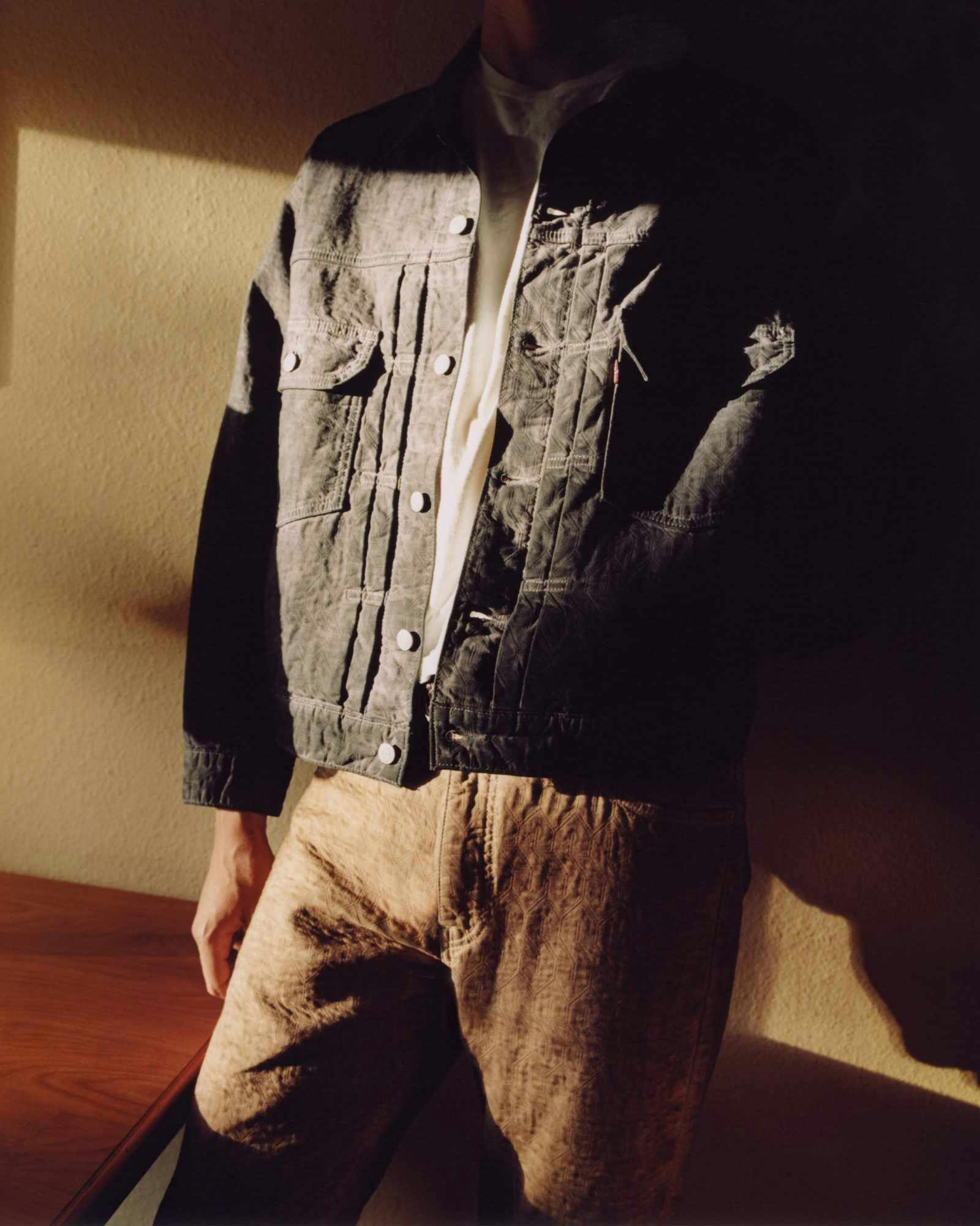 Models wear Stussy & Levi's overdyed brown, beige, and grey denim trucker jackets and 501 jeans