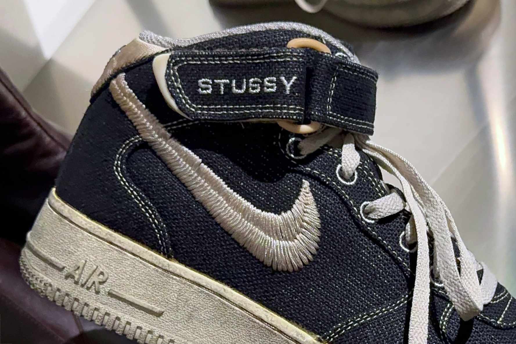 In-hand photos of Stussy & Nike's dyed Air Force 1 Mid sneaker