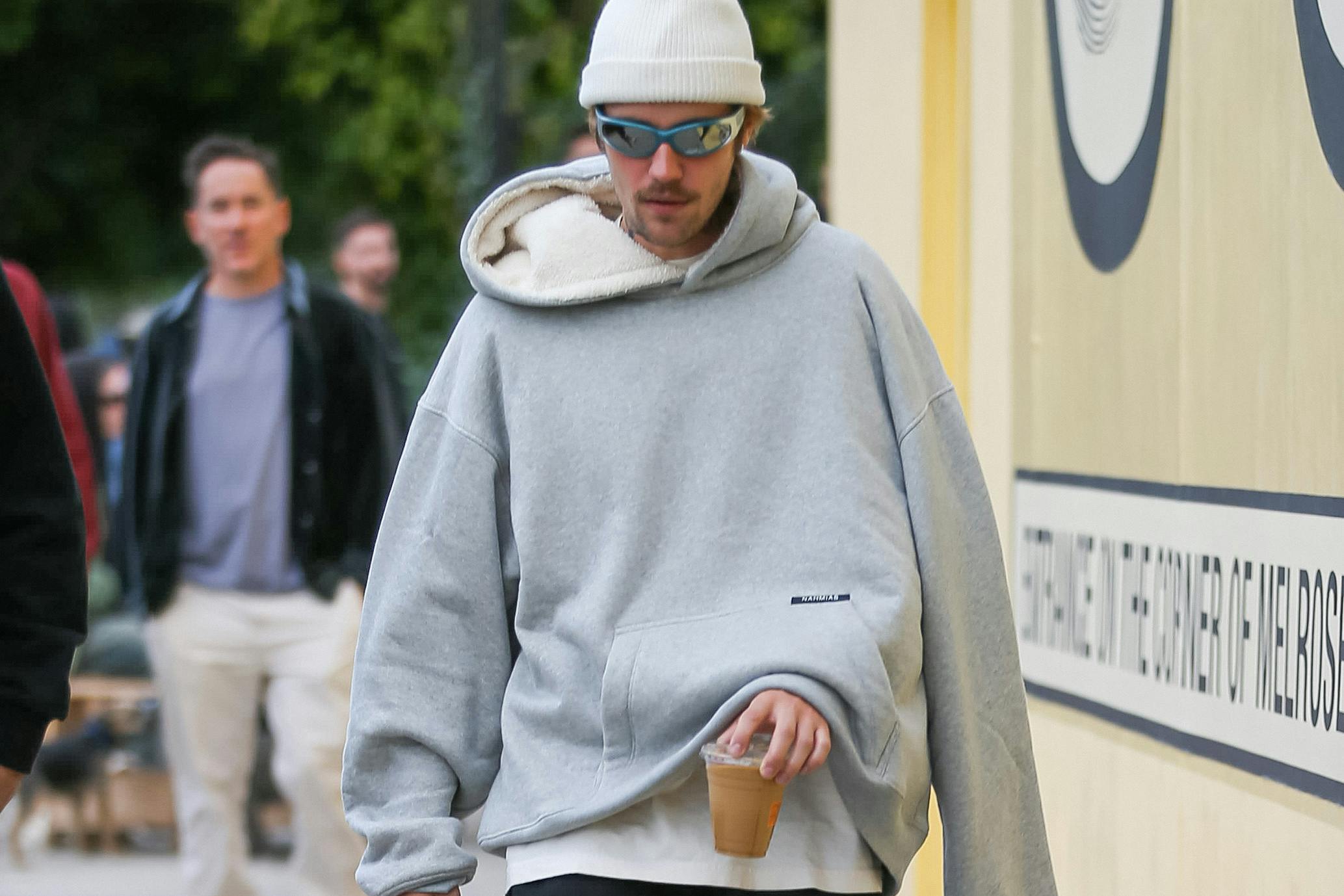 Justin Bieber Wearing a Hoodie With One Sleeve Dangling