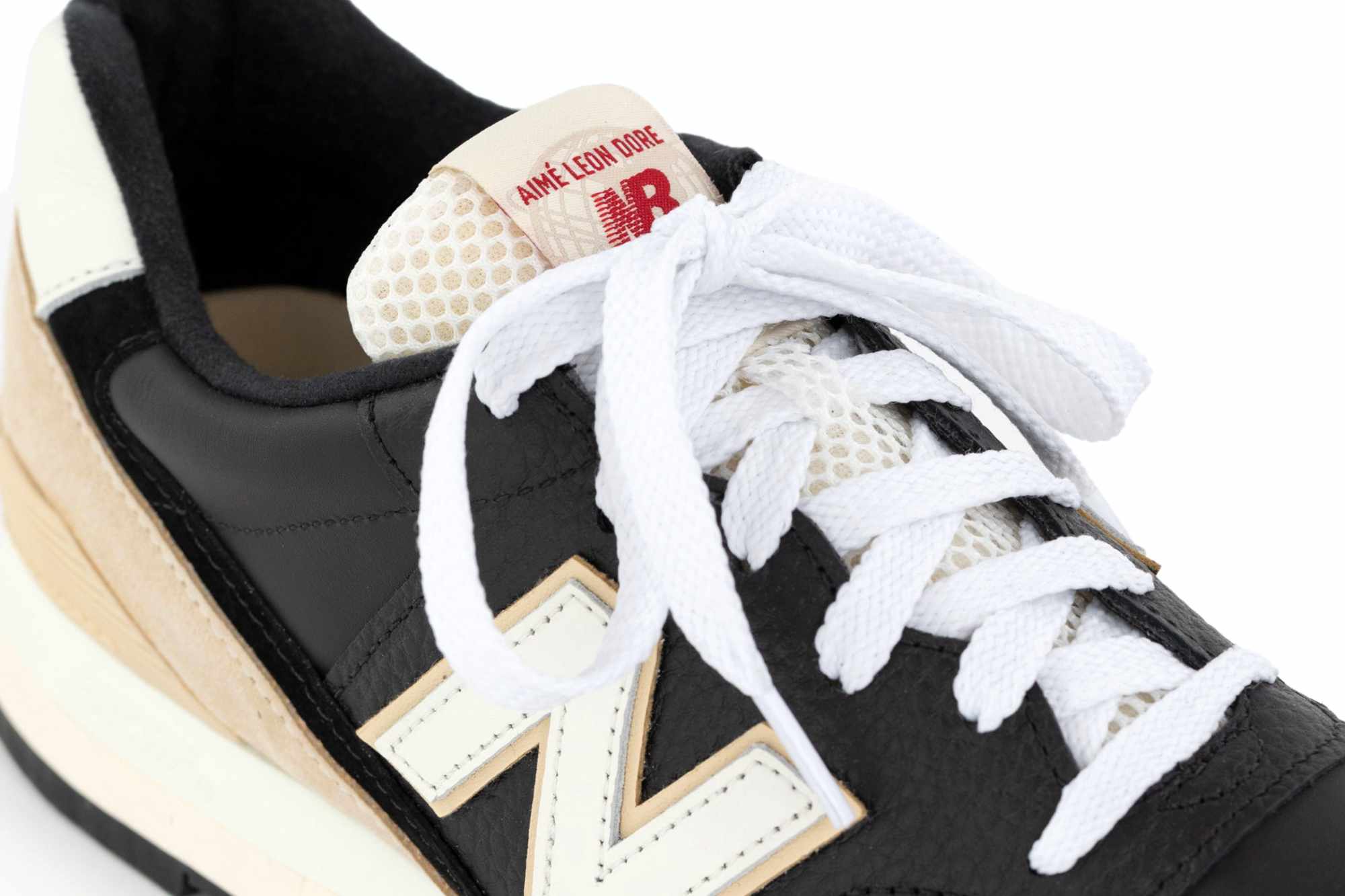 A detailed top-down photo of Aimé Leon Dore and New Balance's 996 sneaker collab in black and white leather