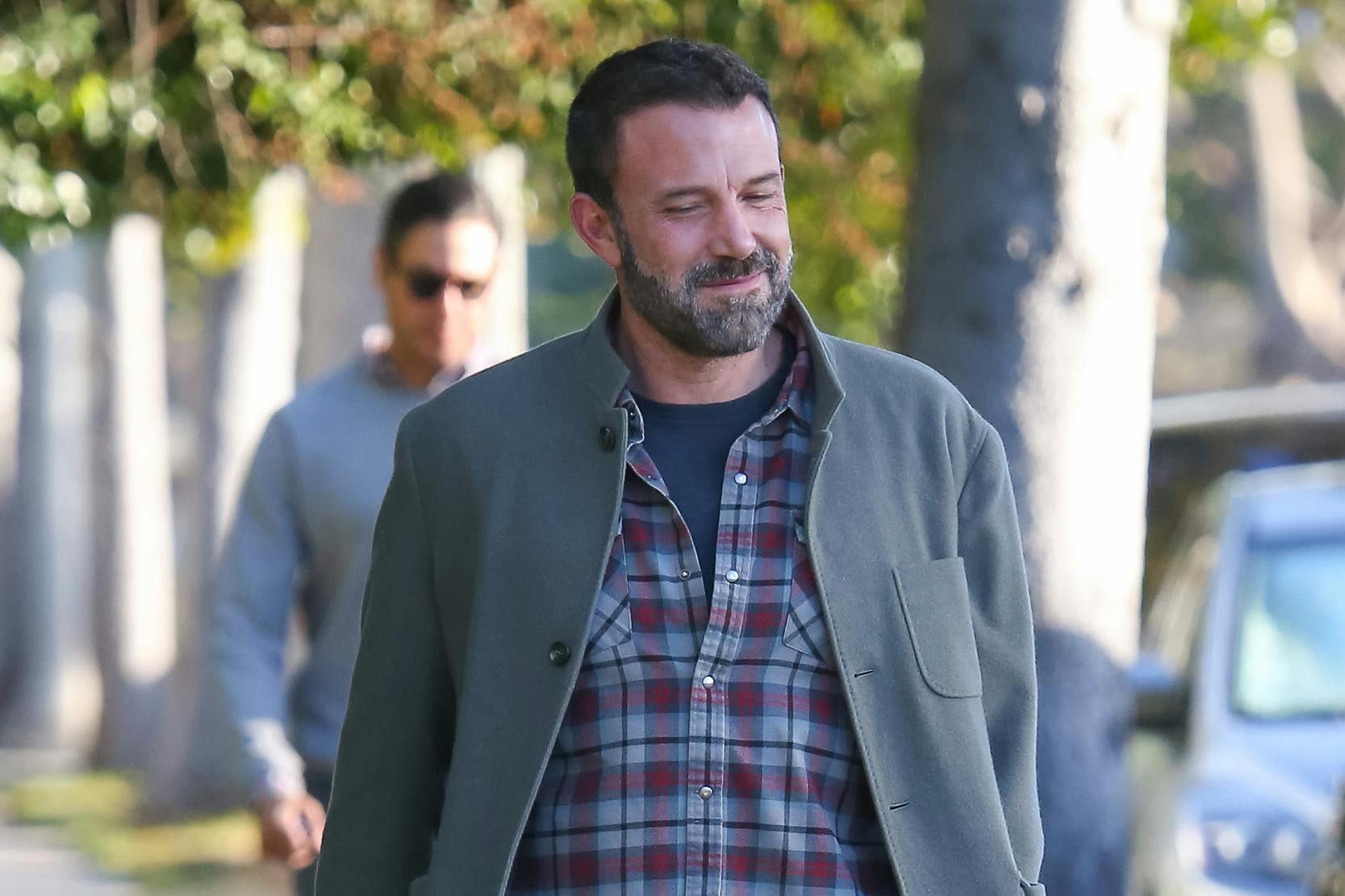 Ben Affleck smiling while wearing Dunkin Donuts Nikes