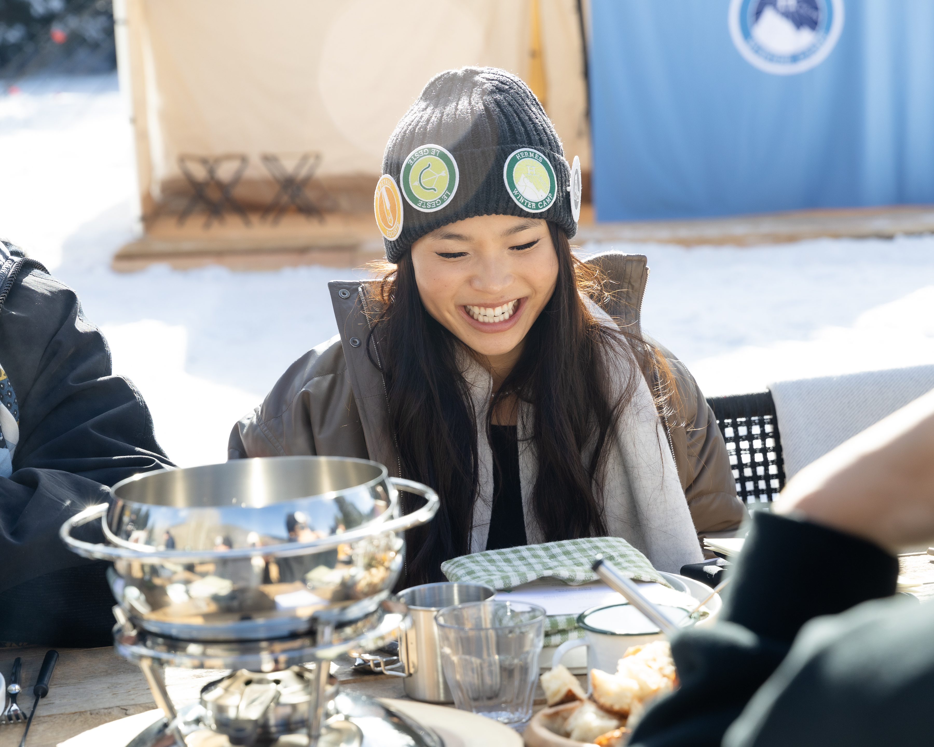 Athlete Chloe Kim seated for lunch at Hermès Winter Camp in Aspen
