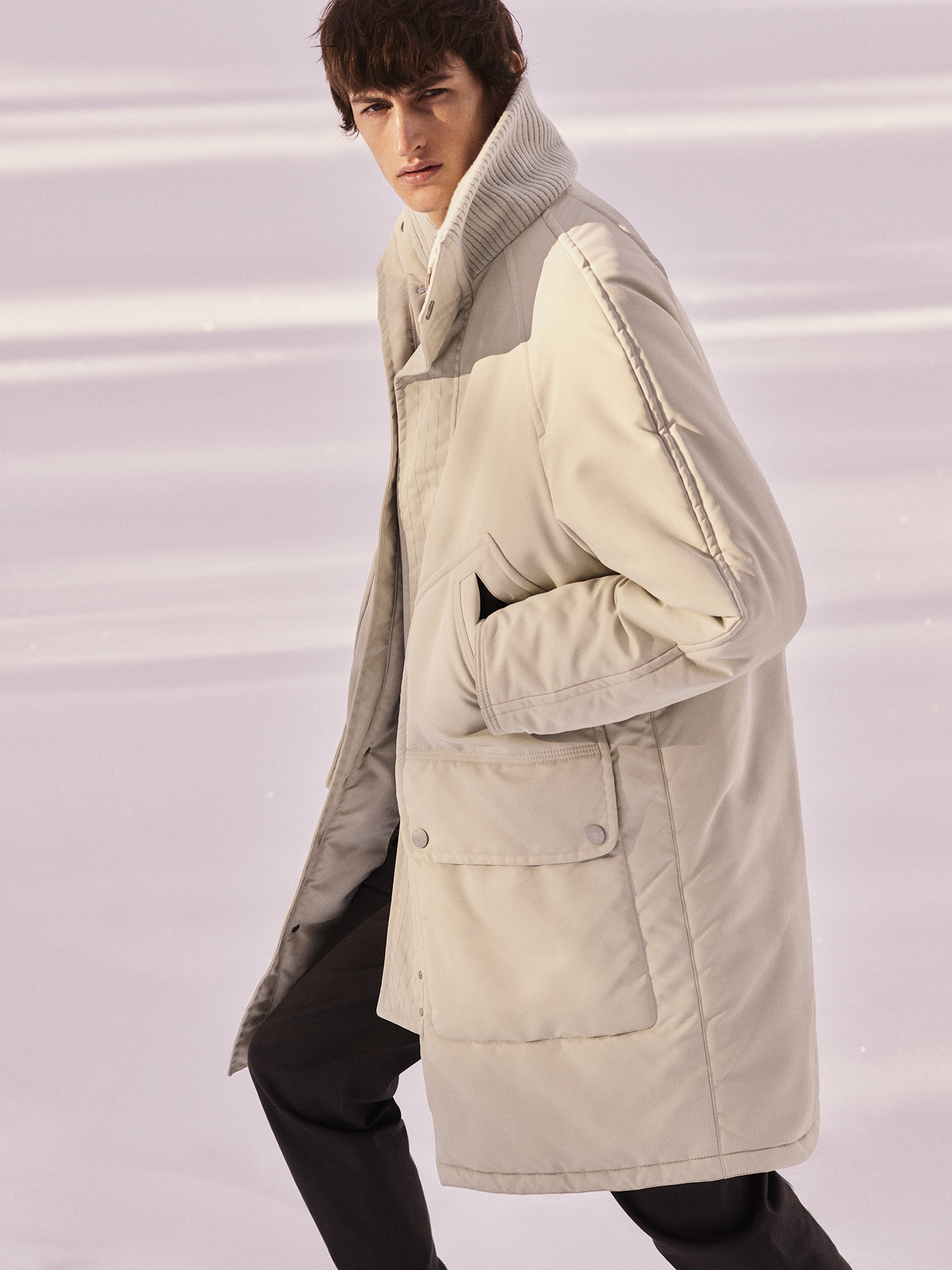 Model wearing a cream winter coat at Hermès Winter Camp
