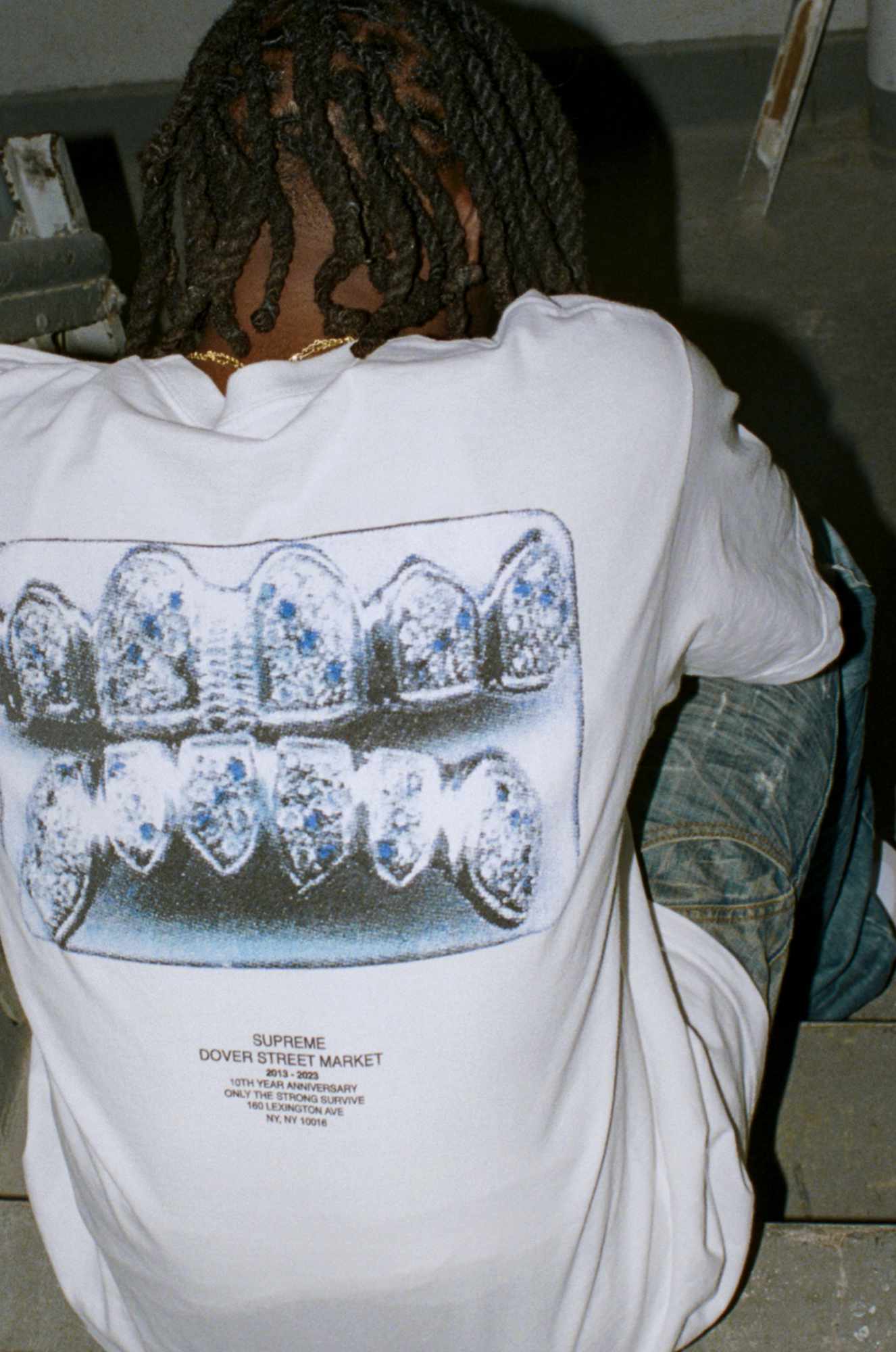 A model wears the white Supreme x Dover Street NYC 10th Anniversary T-shirt