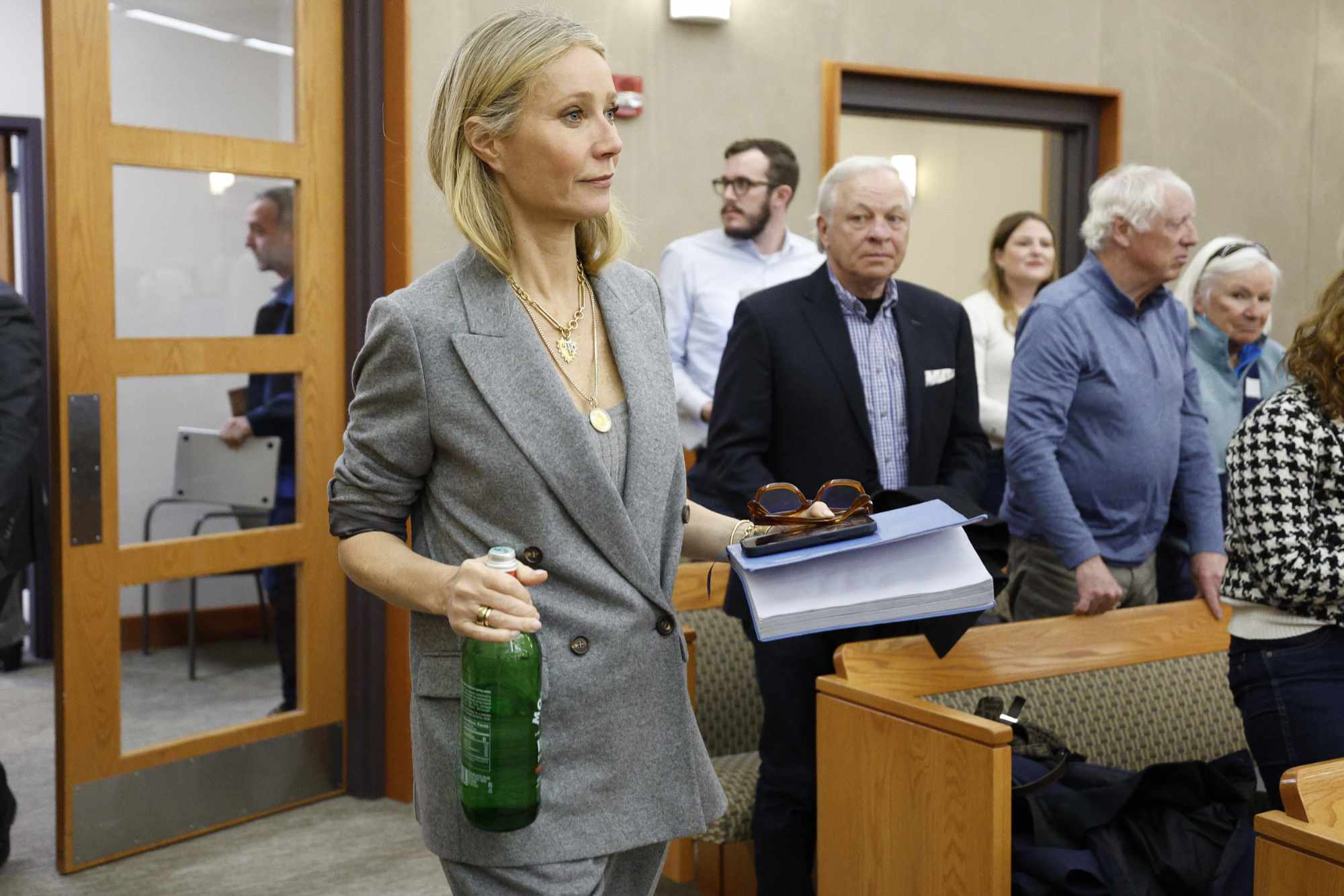 Gwyneth Paltrow enters a Utah courtroom in a grey suit