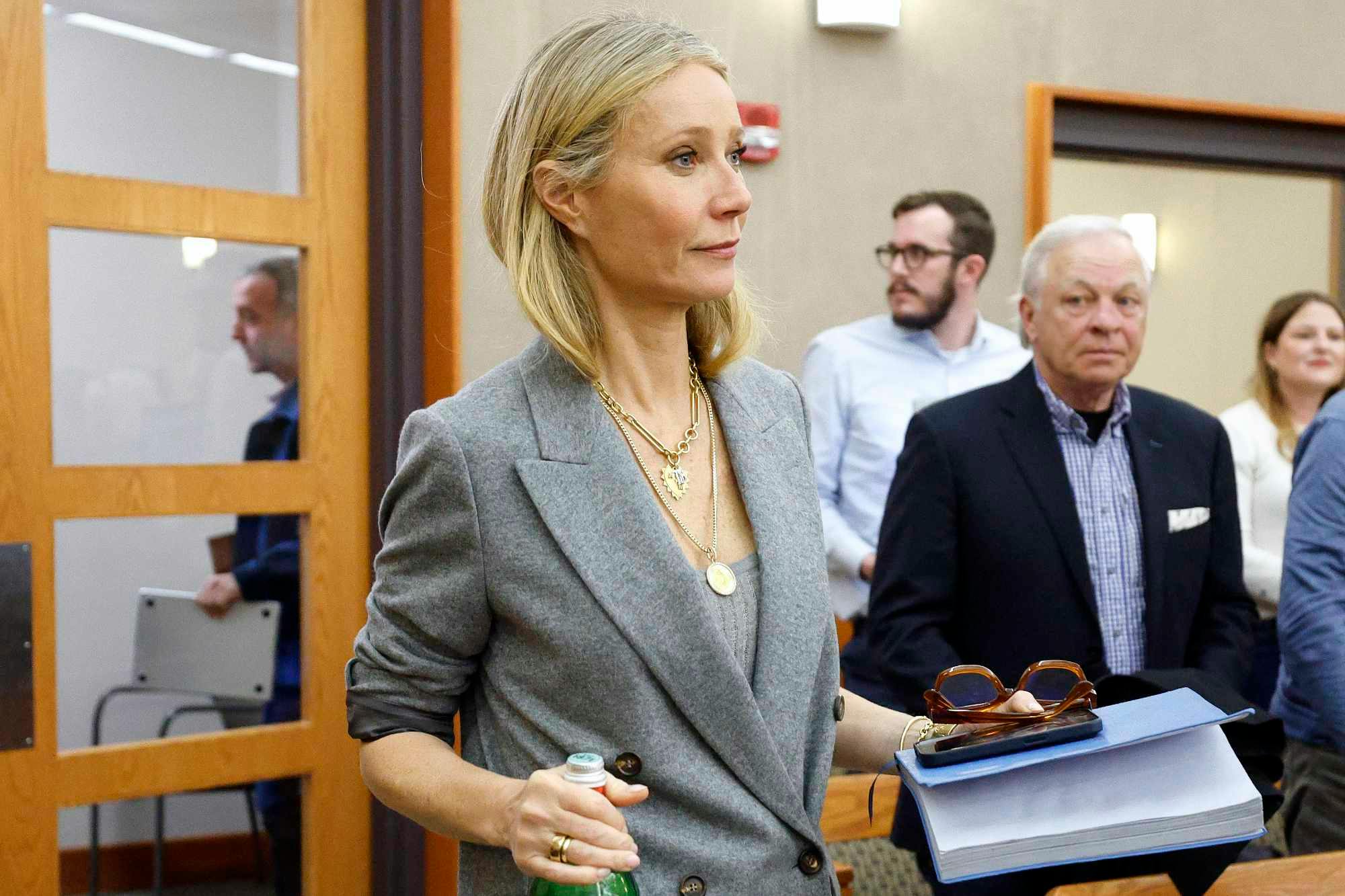 Gwyneth Paltrow enters a Utah courtroom in a grey suit