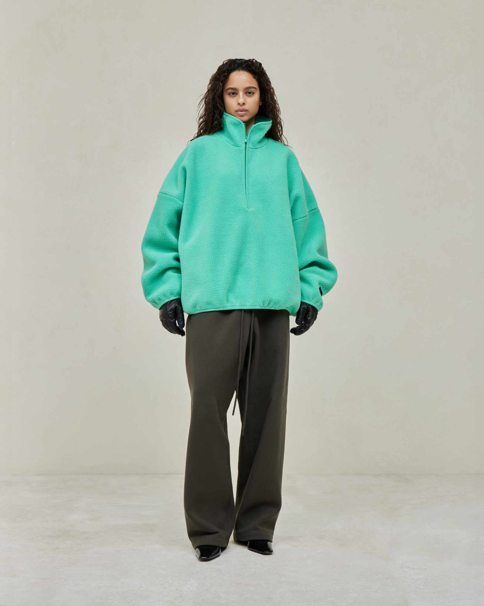 Models wear Fear of God ESSENTIALS' Winter 2023 hoodies, sweatshirts, t-shirts, and sweatpants