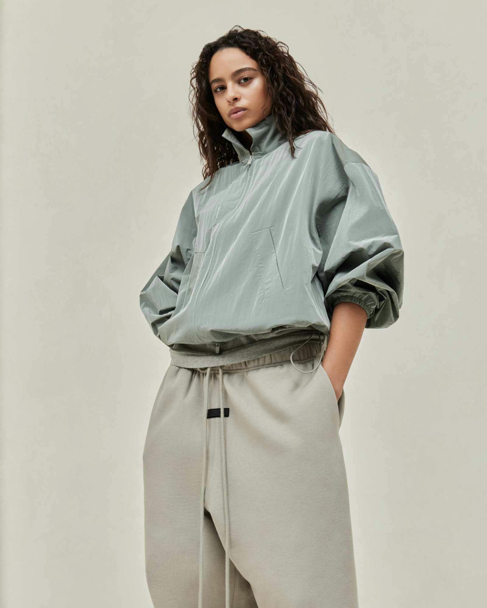 Models wear Fear of God ESSENTIALS' Winter 2023 hoodies, sweatshirts, t-shirts, and sweatpants