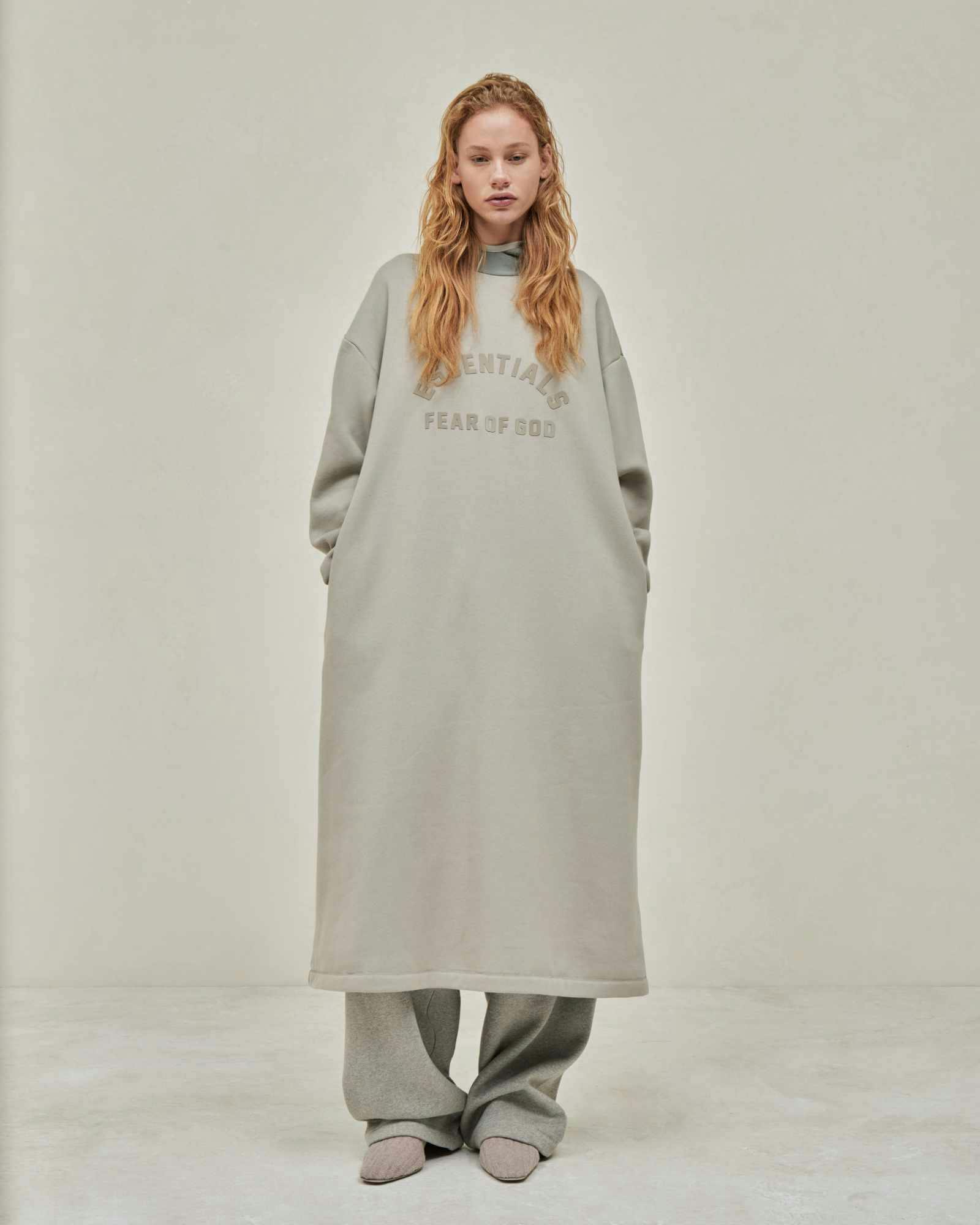 Models wear Fear of God ESSENTIALS' Winter 2023 hoodies, sweatshirts, t-shirts, and sweatpants