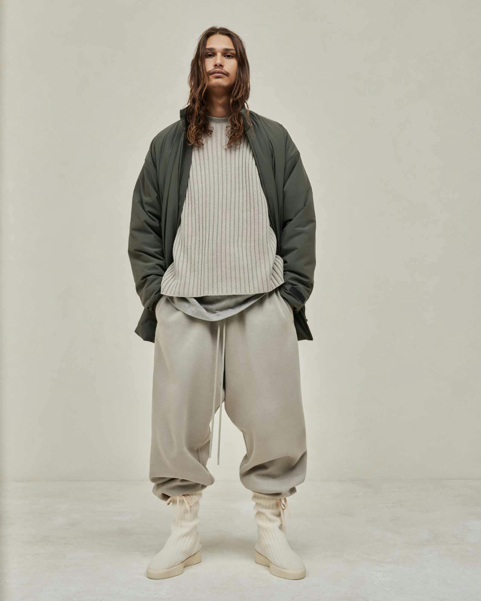 Models wear Fear of God ESSENTIALS' Winter 2023 hoodies, sweatshirts, t-shirts, and sweatpants