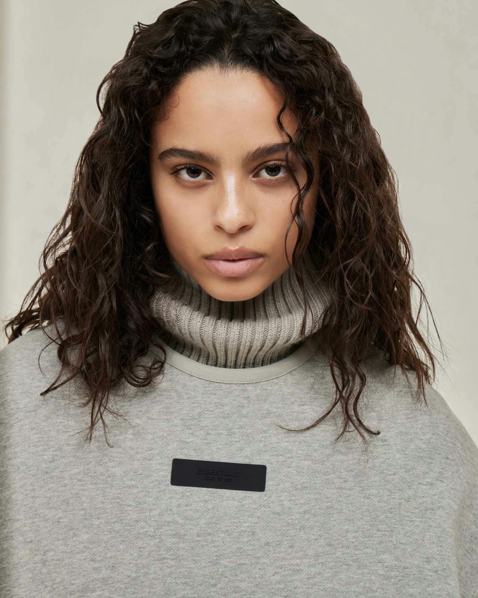 Models wear Fear of God ESSENTIALS' Winter 2023 hoodies, sweatshirts, t-shirts, and sweatpants