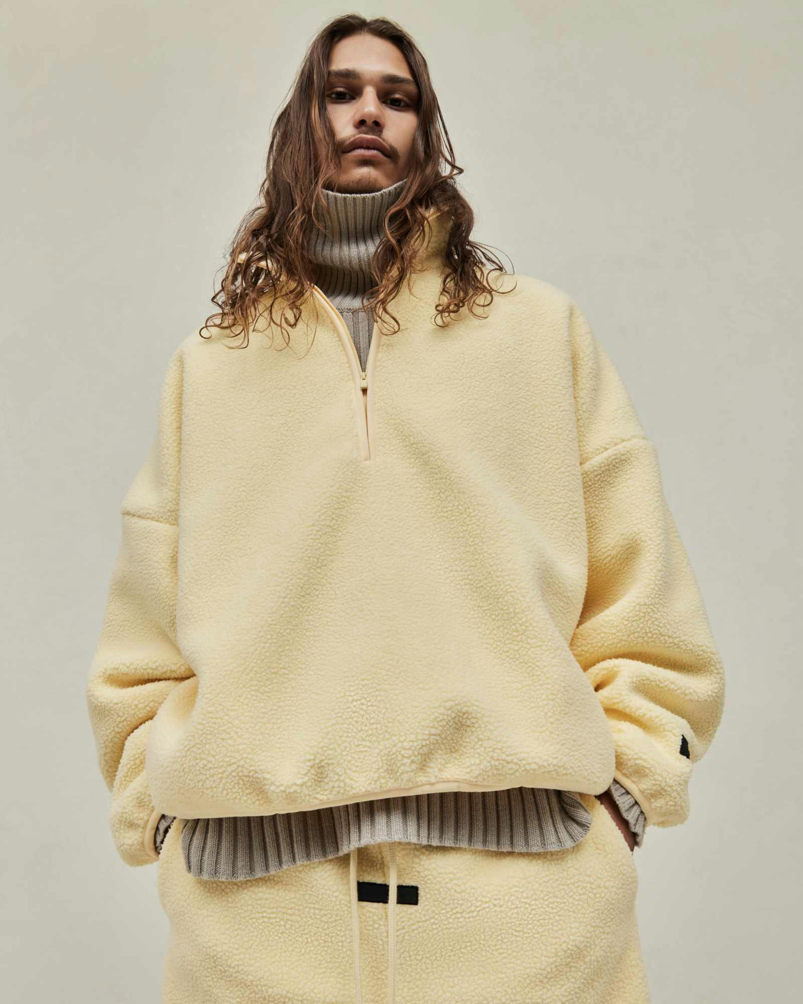 Models wear Fear of God ESSENTIALS' Winter 2023 hoodies, sweatshirts, t-shirts, and sweatpants